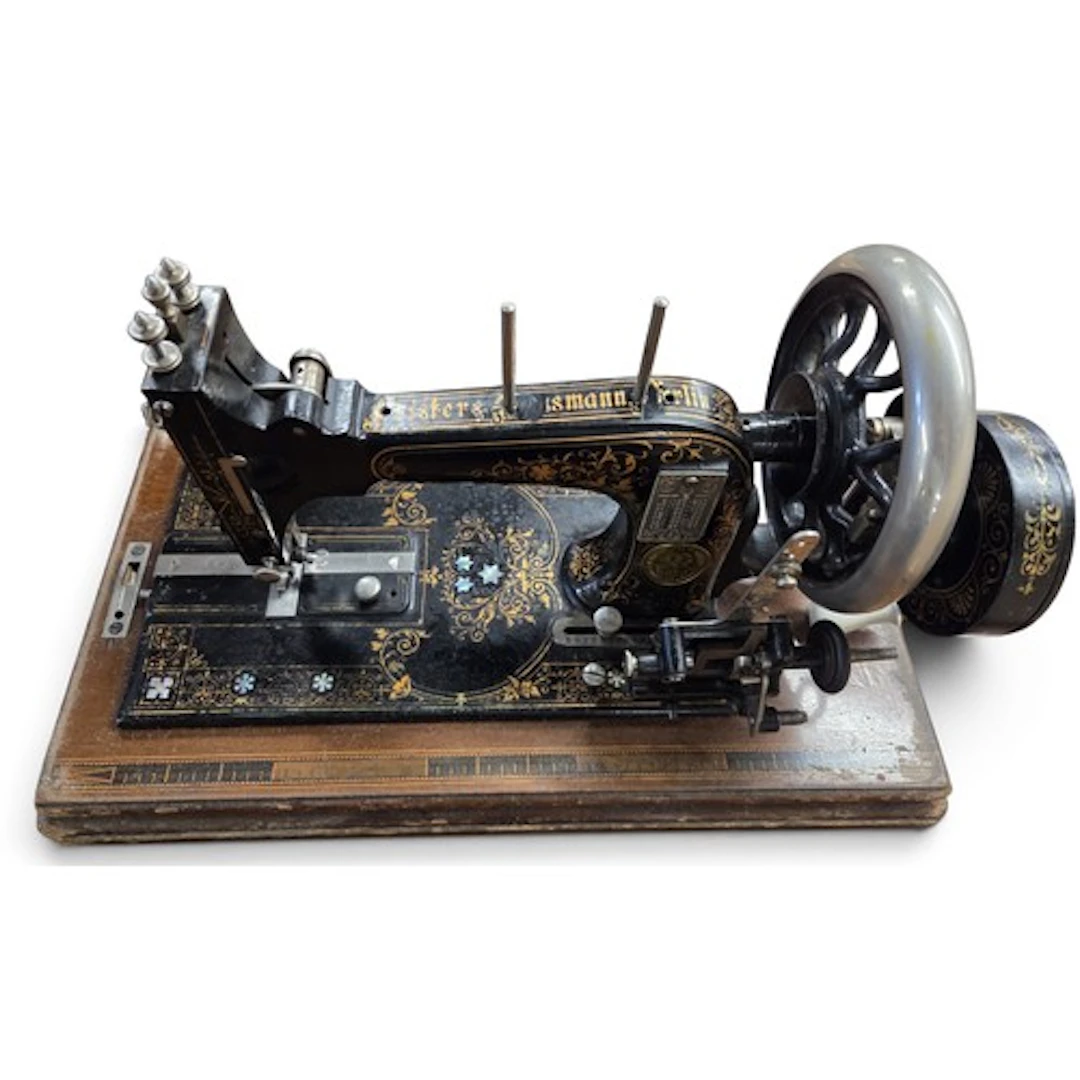 A cased Frister & Rossmann Sewing Machine in a Walnut case. ...