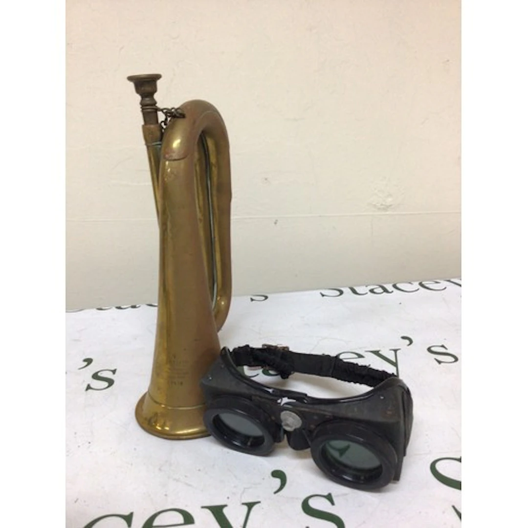 A Military issue brass bugle and a pair of Polaroid type gog...
