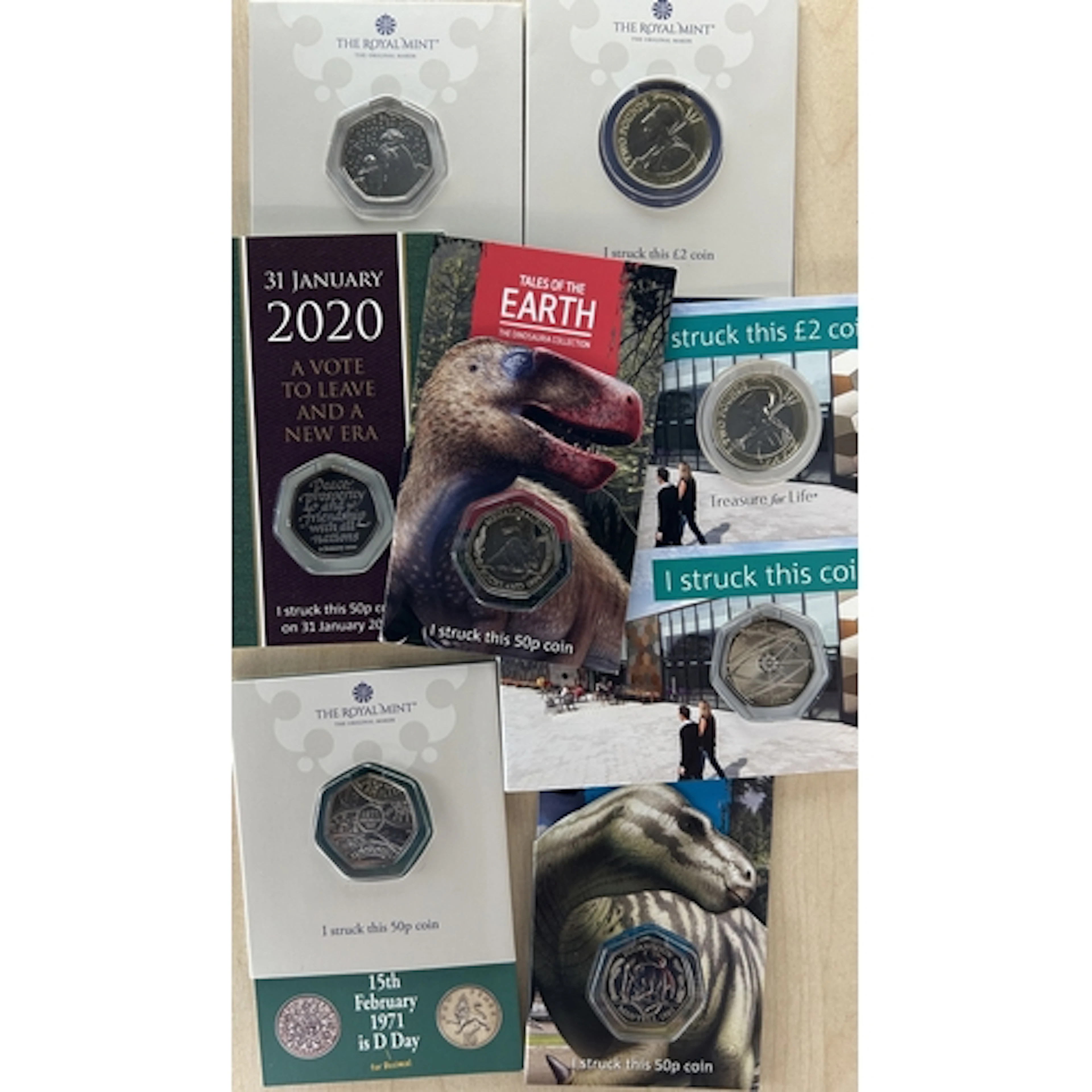 A group of eight Royal Mint Experience Strike Your Own cupro...
