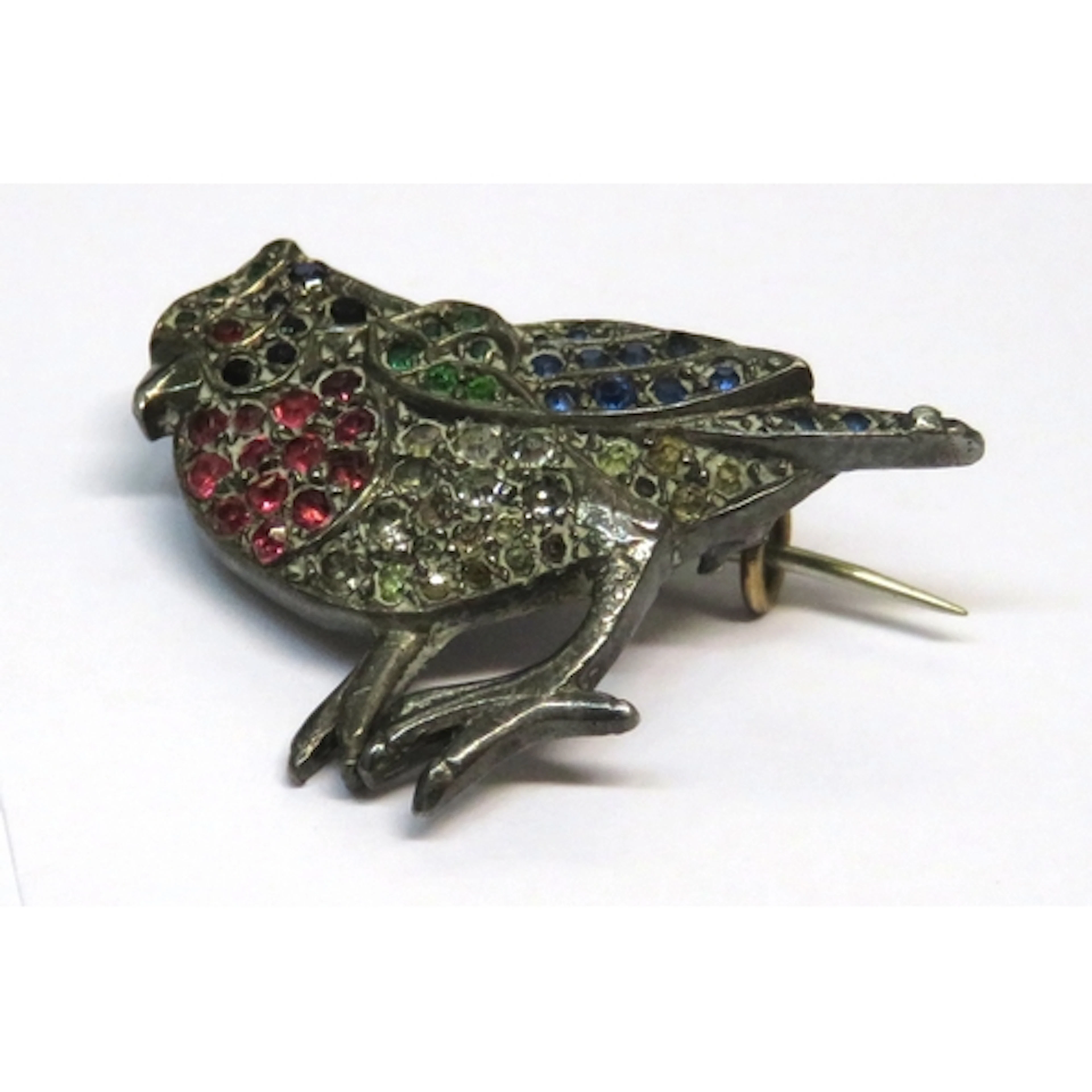 Small paste set white metal brooch in the form of a bird