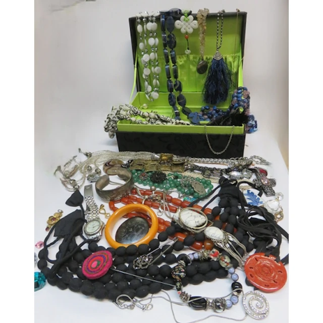 Quantity of costume jewellery in a black fabric jewellery bo...