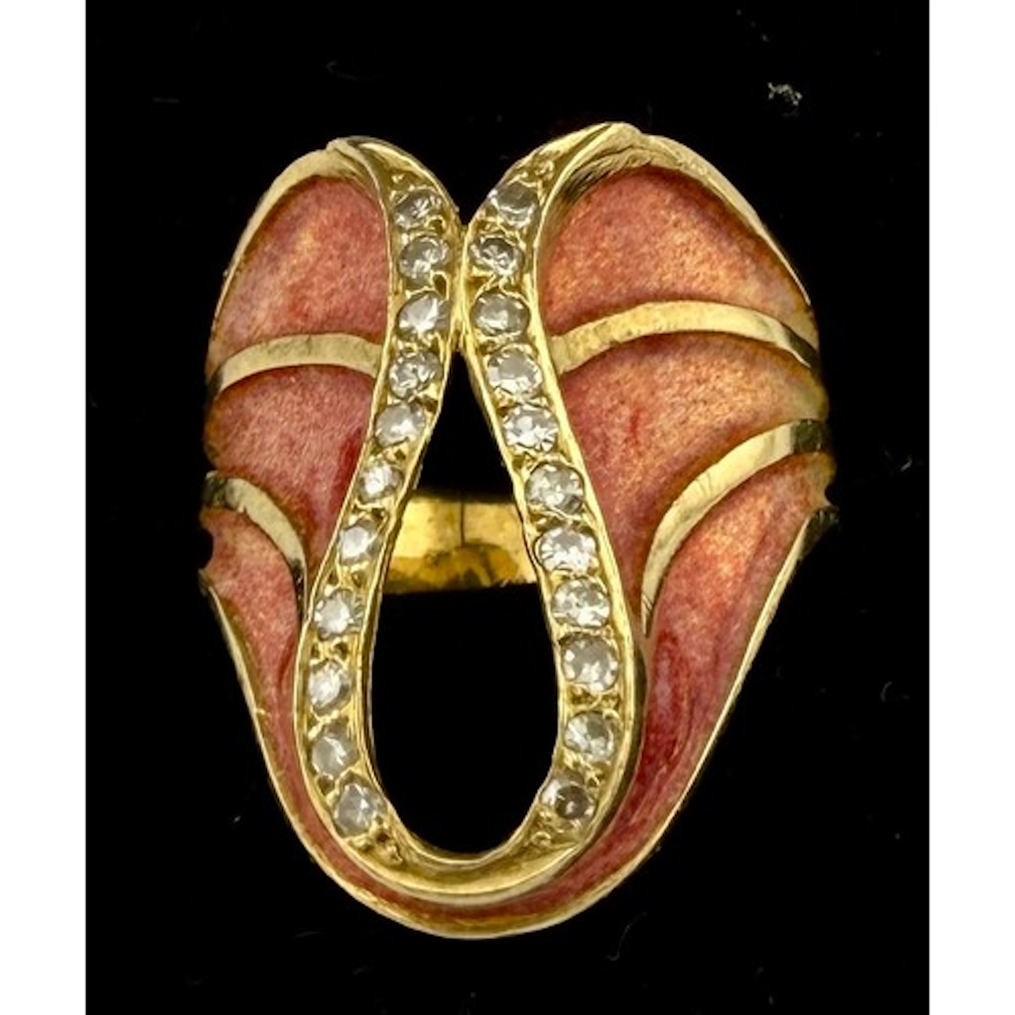 A yellow metal and enamel ring set with diamonds, tests as a...
