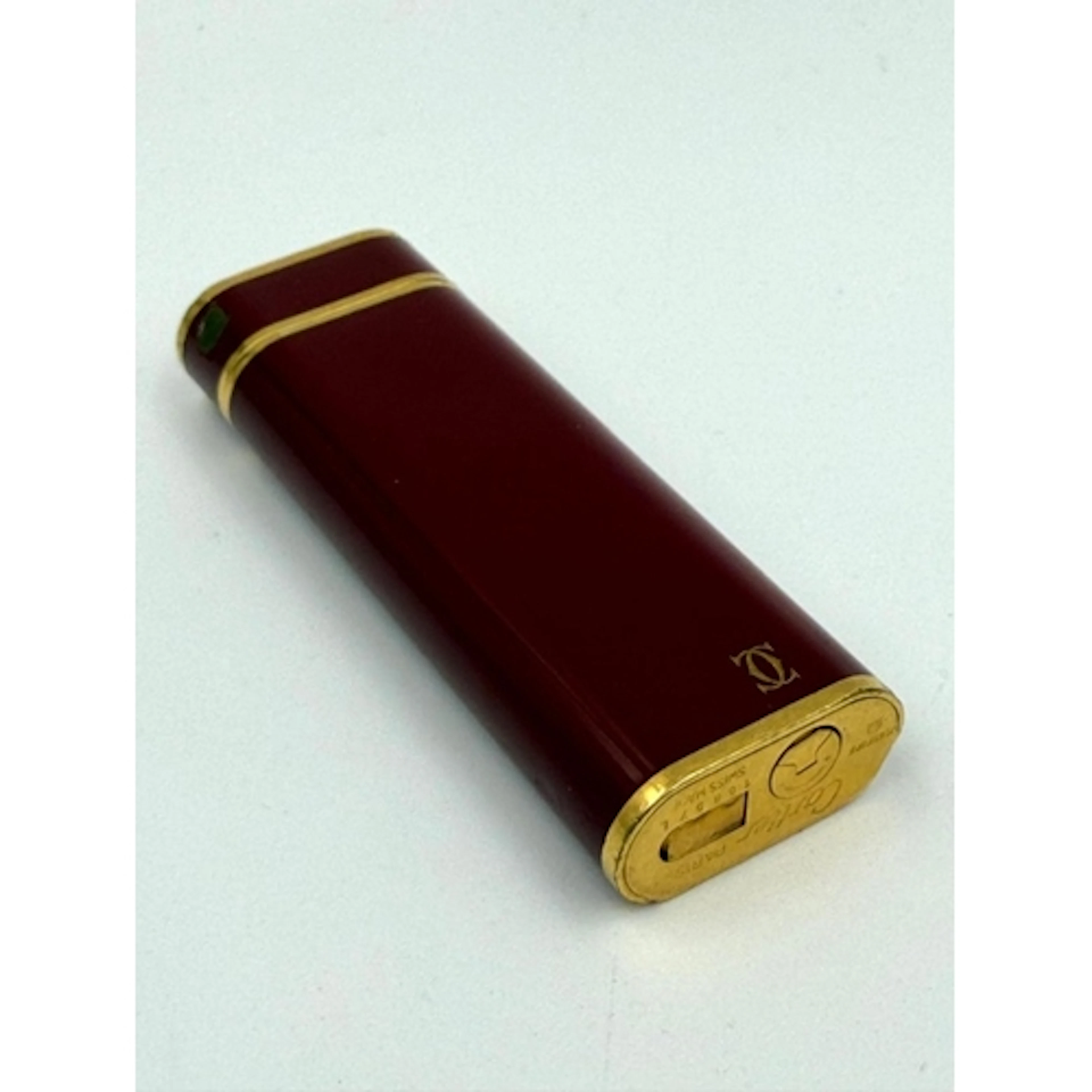 A Cartier Bordeaux re lacquer and gold plated lighter, from ...