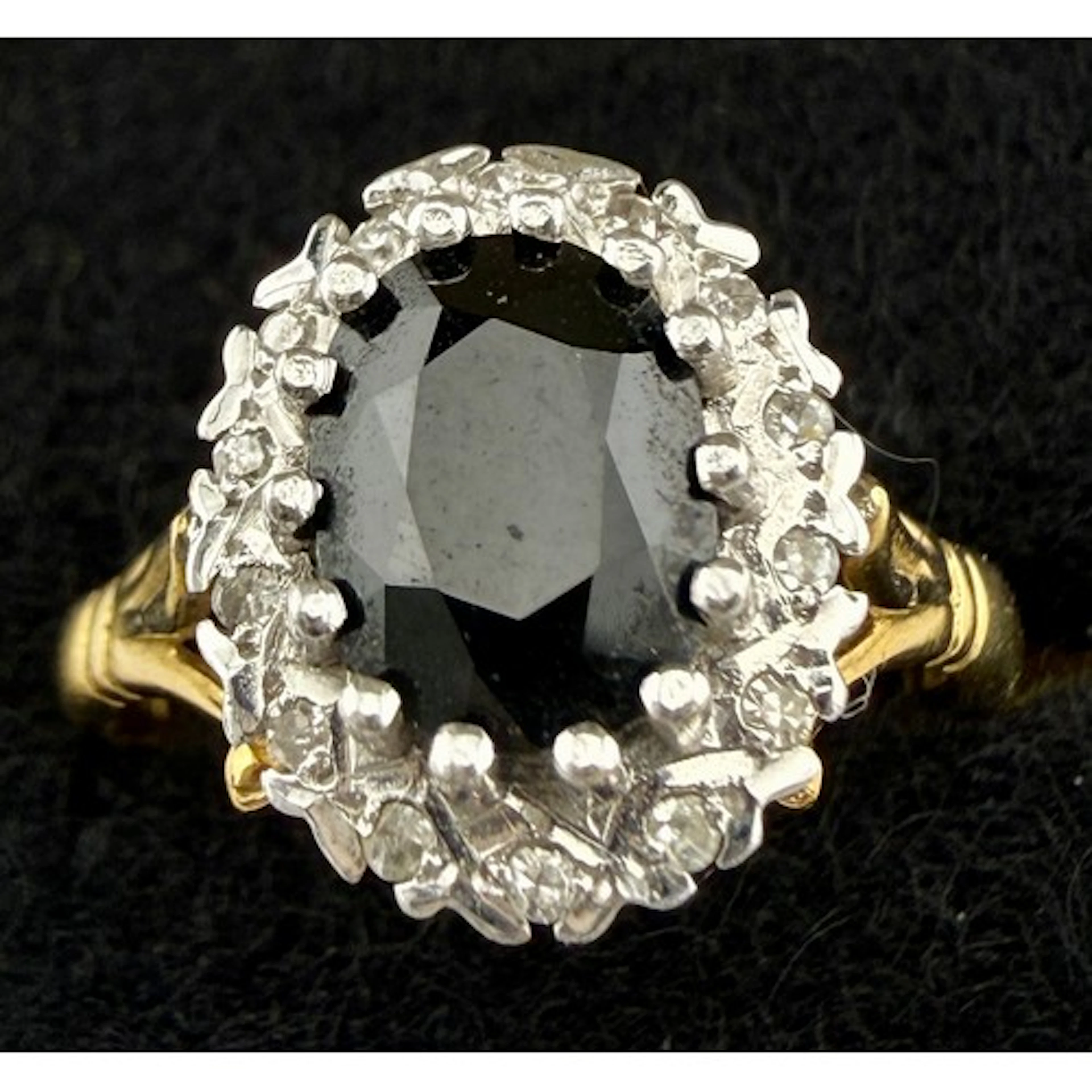 An 18 carat gold sapphire and diamond cluster ring. Size O/P...