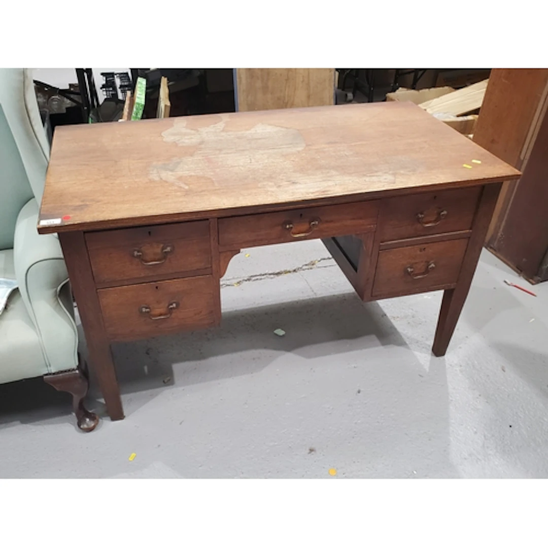 An oak Desk fitted five drawers and raised on square tapered...