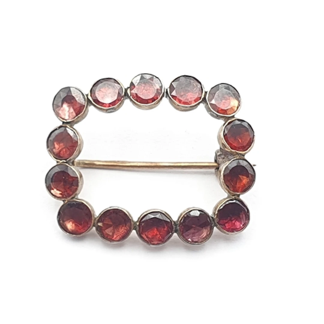 A Georgian Garnet Brooch, rubover-set flat-cut garnets in un...