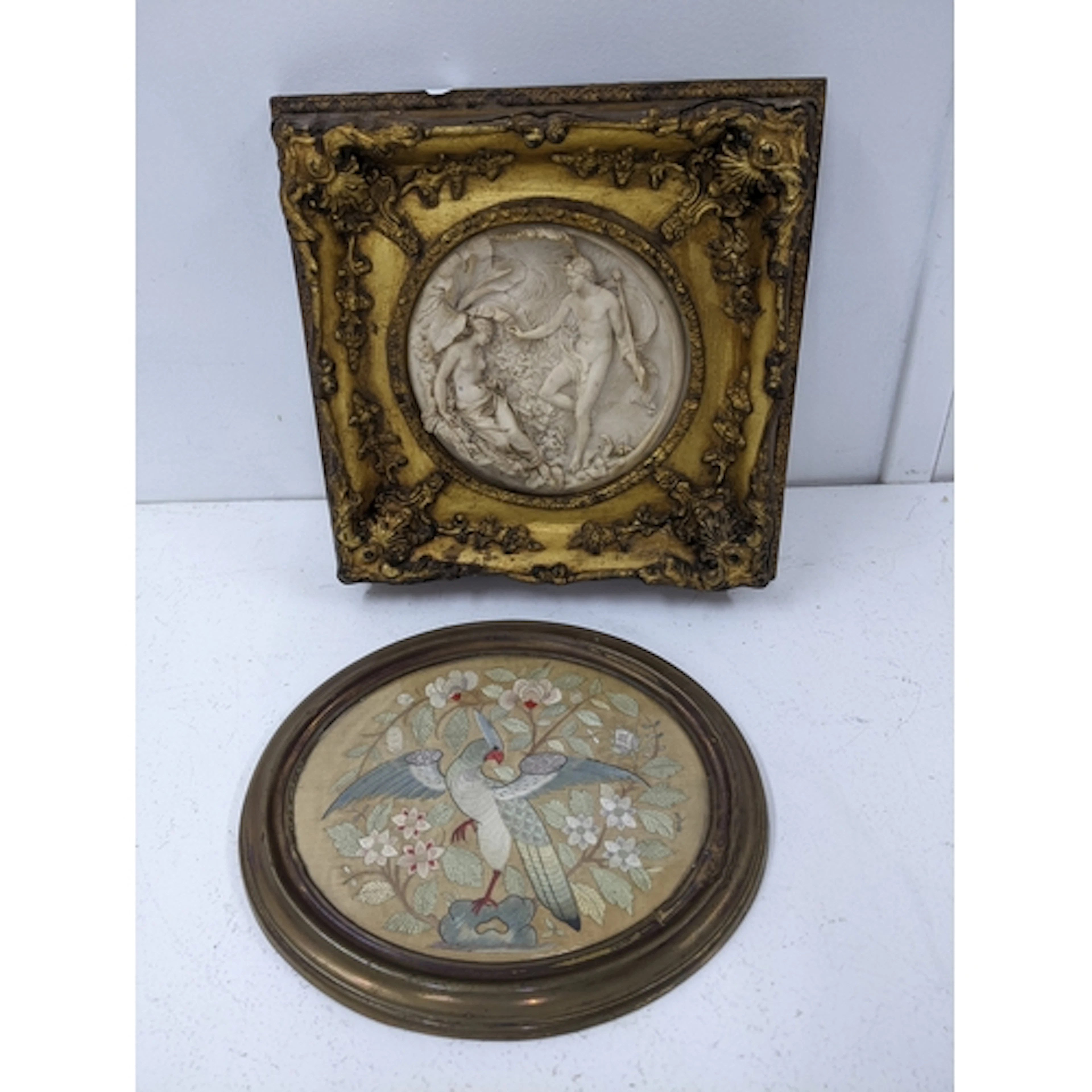 A circular composition white marble relief plaque mounted in...