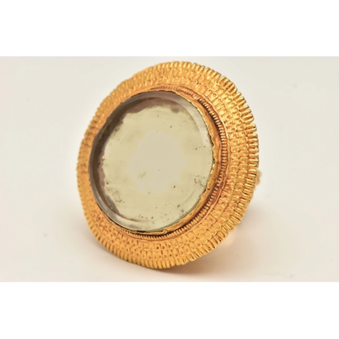 A LARGE YELLOW METAL 19TH CENTURY INDIAN MIRROR RING, handma...