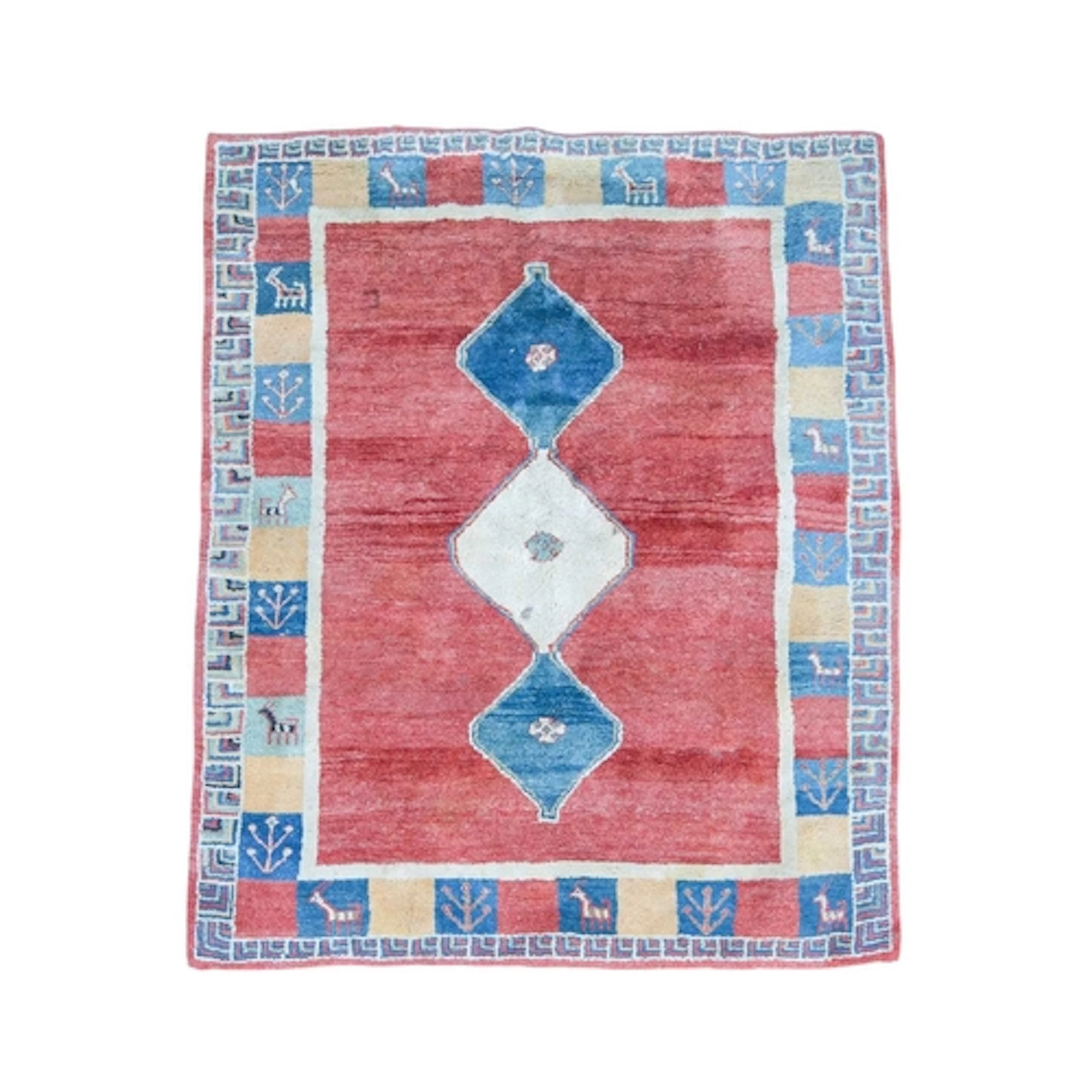 A Gabbeh rug. A deep pile wool carpet in red, blue and ochre...