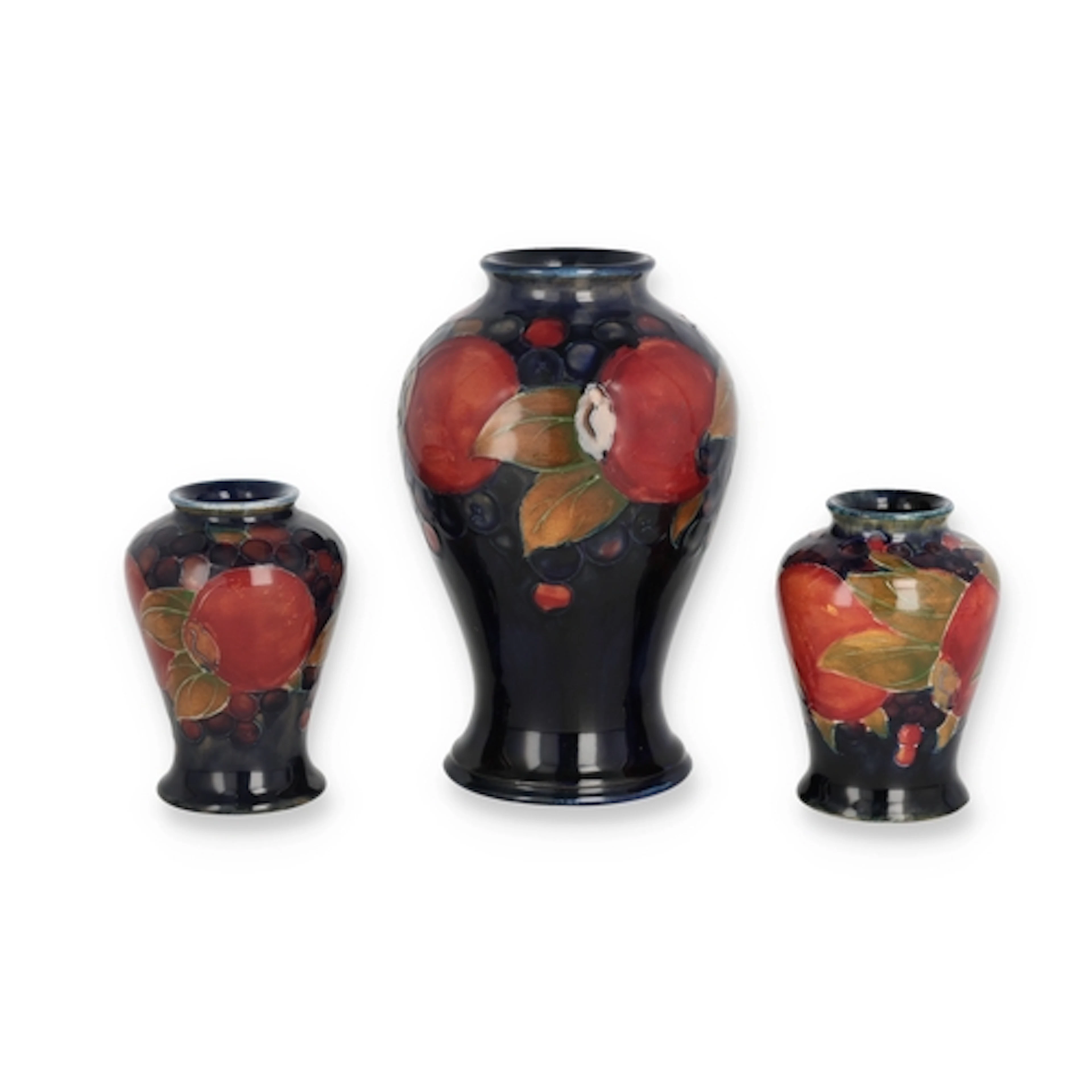 MOORCROFT: A SET OF THREE POMEGRANATE VASES