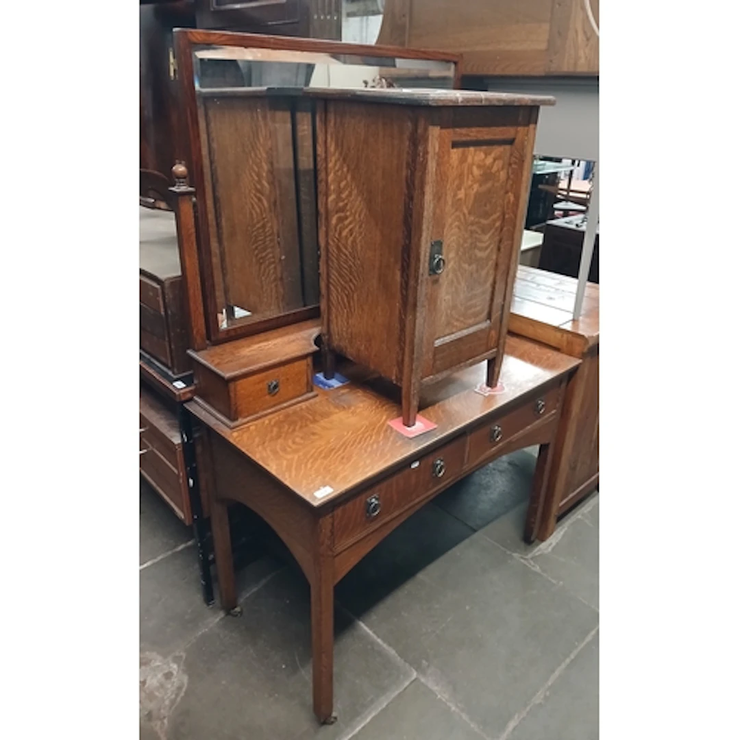 An Arts and Crafts style oak dressing table and matching pot...