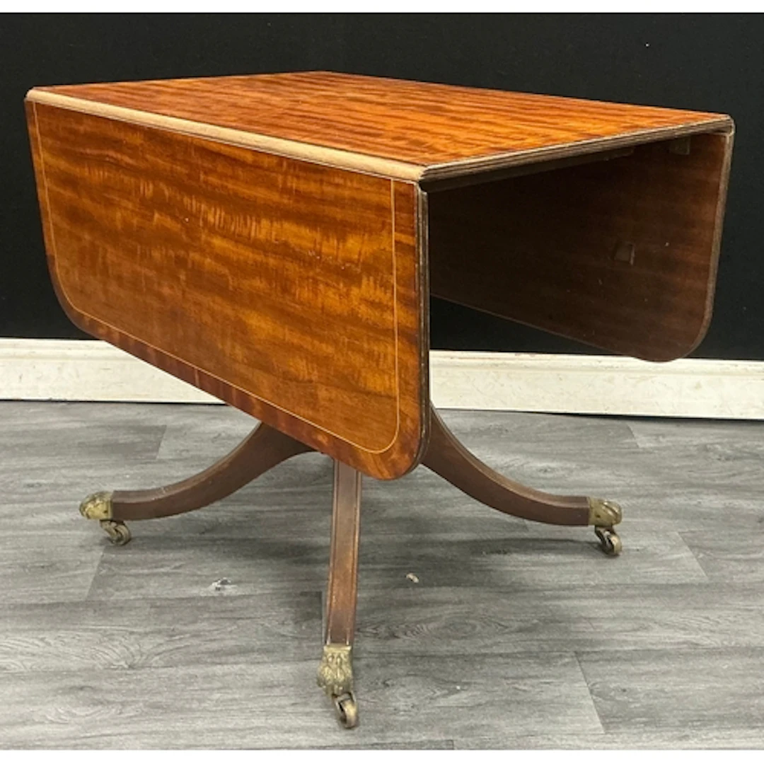 A regency style drop leaf table with boxwood stringing, supp...