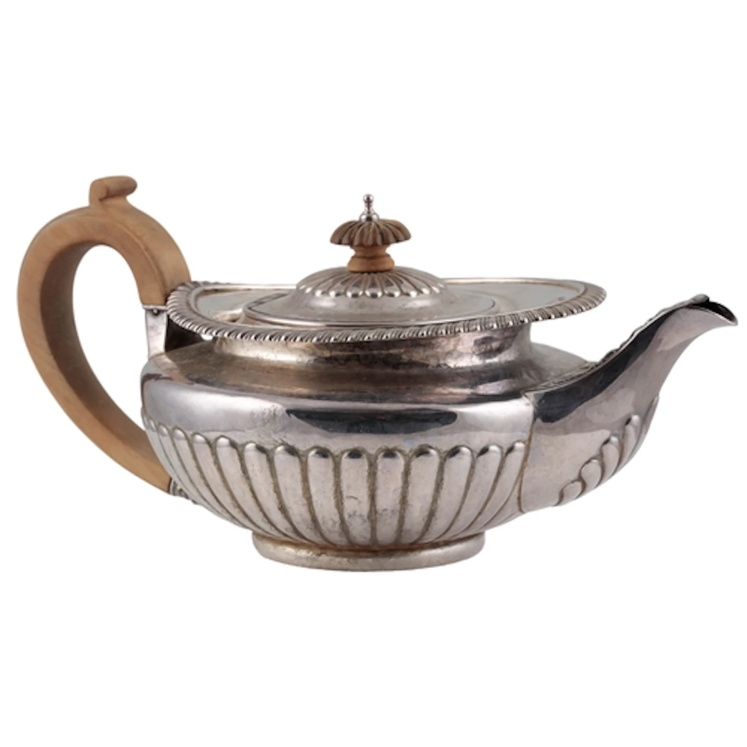 A George IV demi-fluted silver teapot, by Eames & Barnard, o...