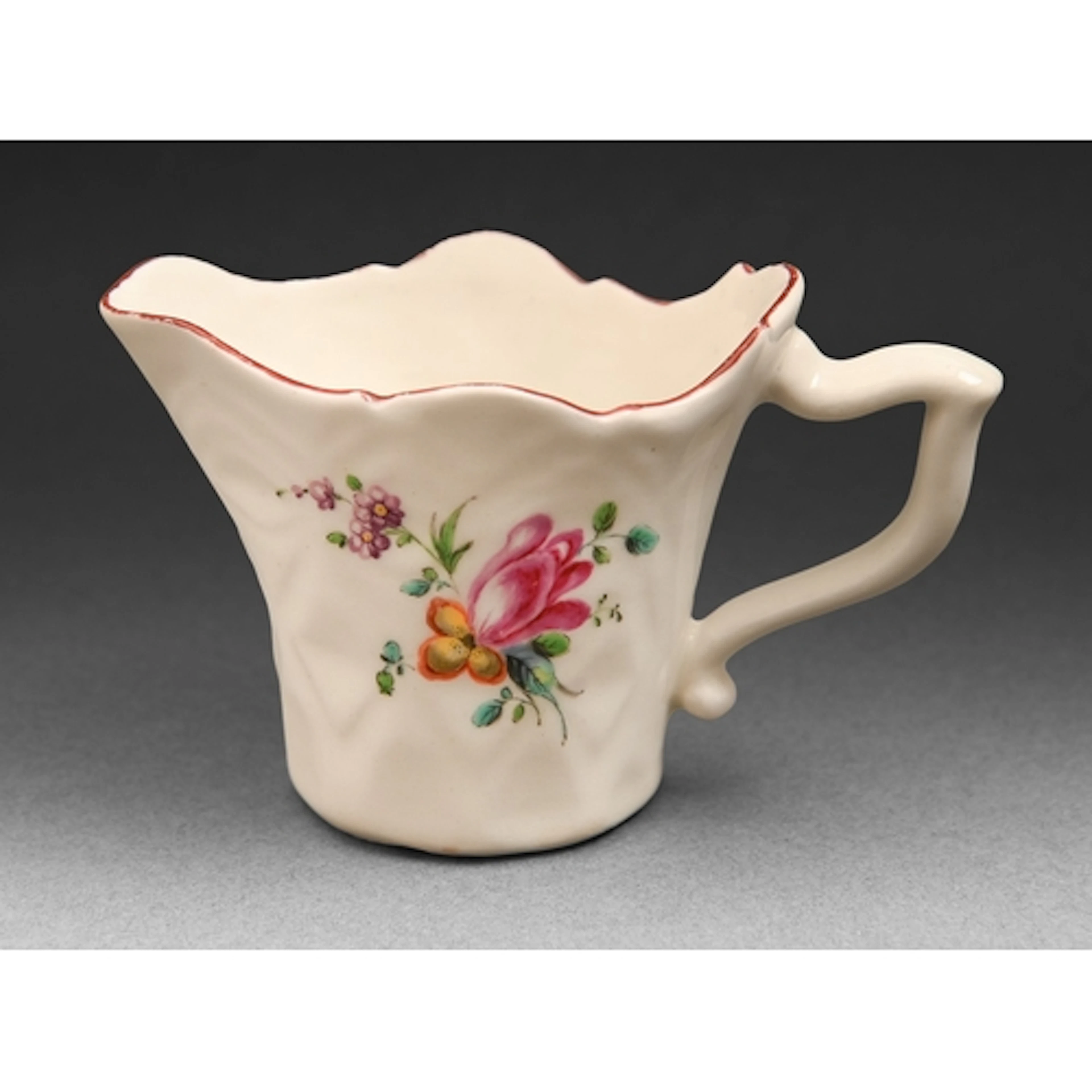 A Derby cream jug, c1765, of lozenge-moulded form with wishb...