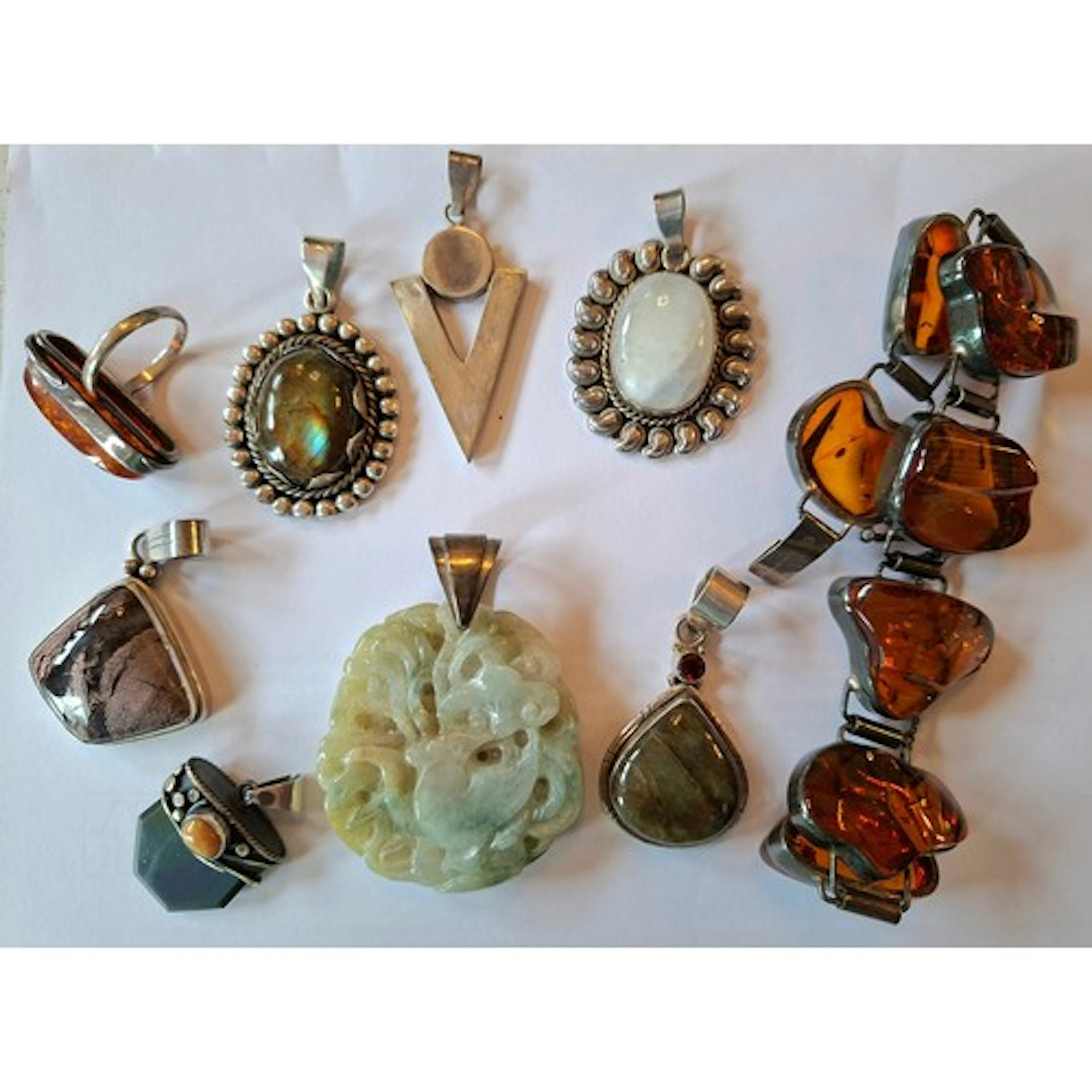 A group of 7 silver, white metal and stone pendants to inclu...