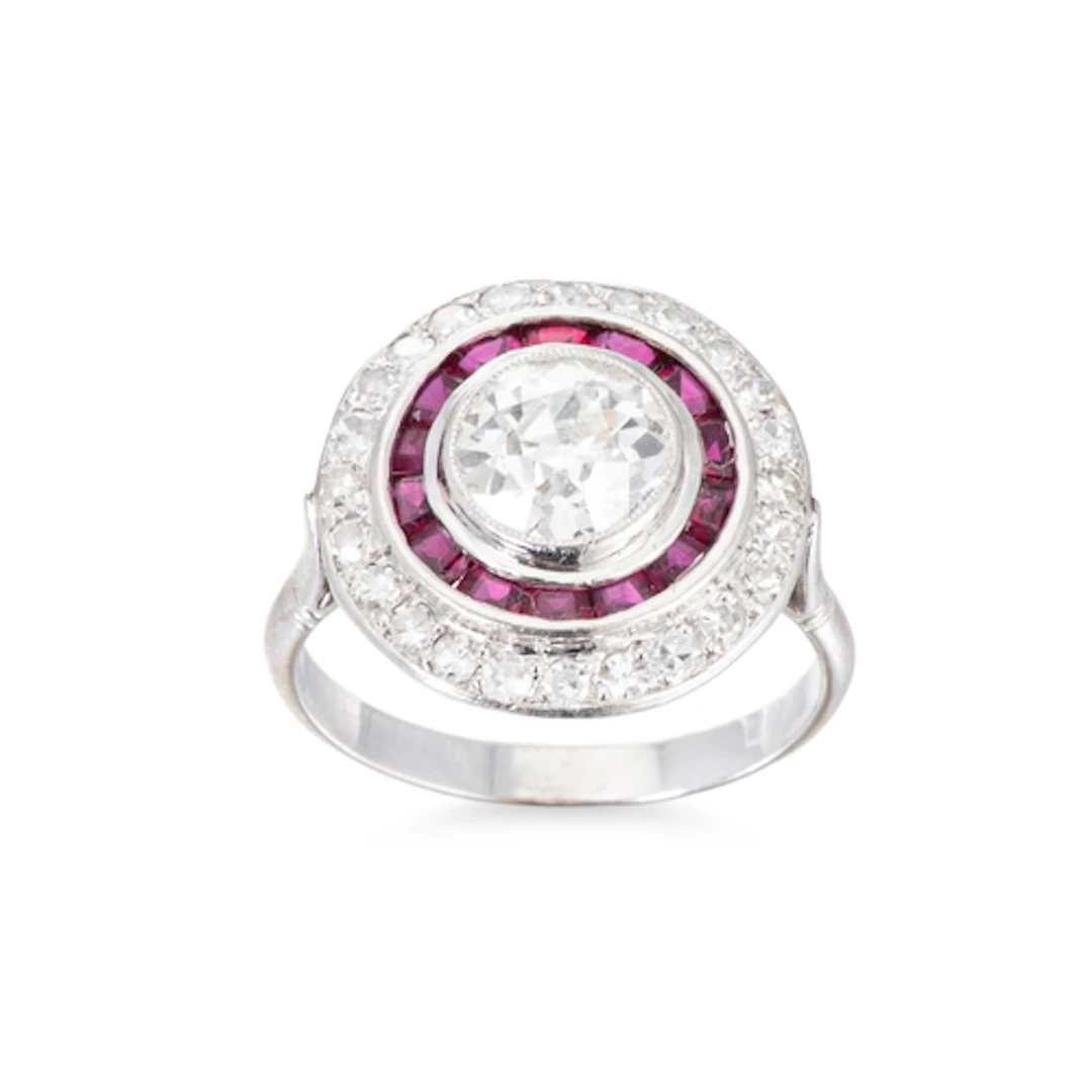 A DIAMOND AND RUBY TARGET CLUSTER RING, the central old cut ...