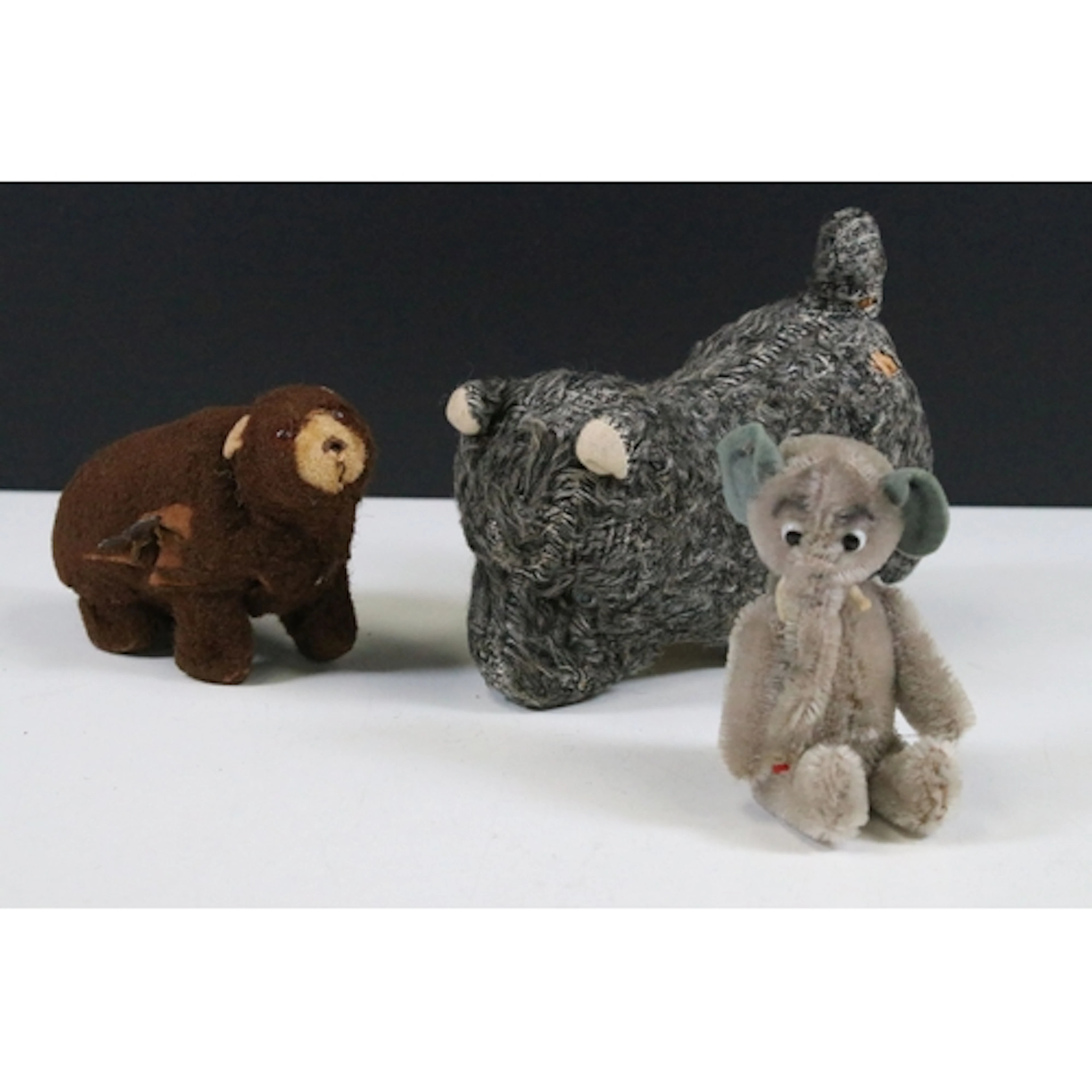 Three miniature teddy bears and clockwork models to include ...