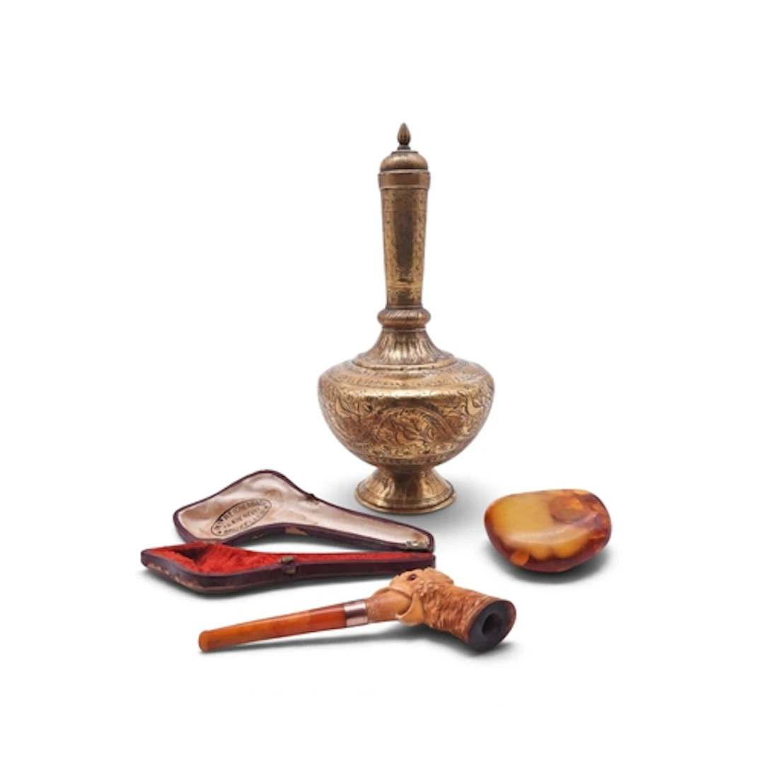 An Indian brass water sprinkler engraved with animals and fo...