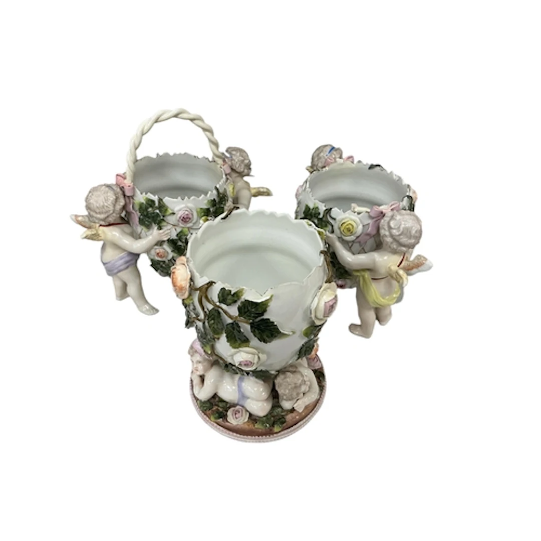 A Sitzendorf floral encrusted cherub and egg porcelain centr...