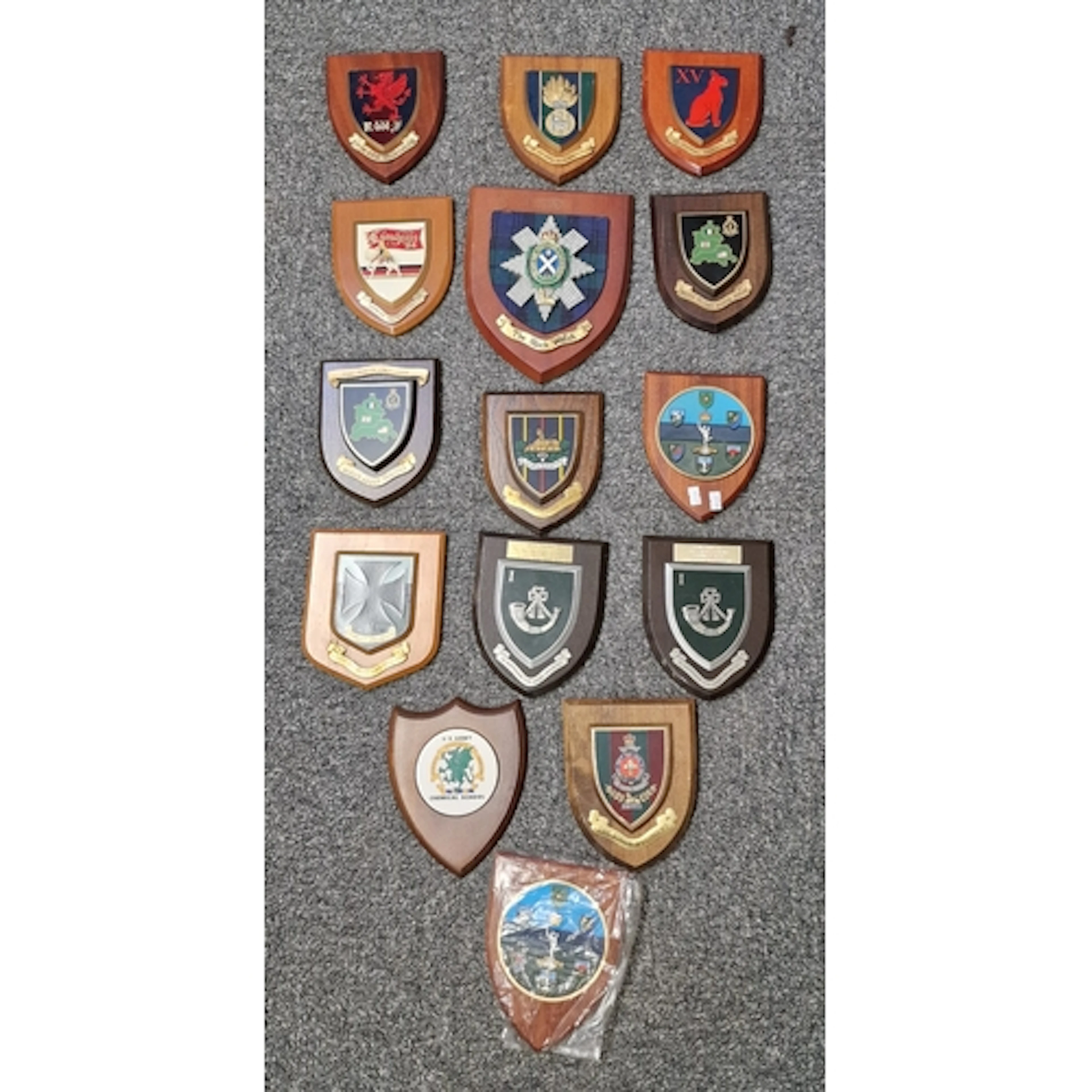 Collection of military regimental and unit shields and crest...