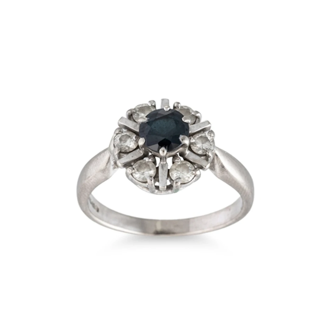 A SAPPHIRE AND DIAMOND CLUSTER RING, of circular form, mount...
