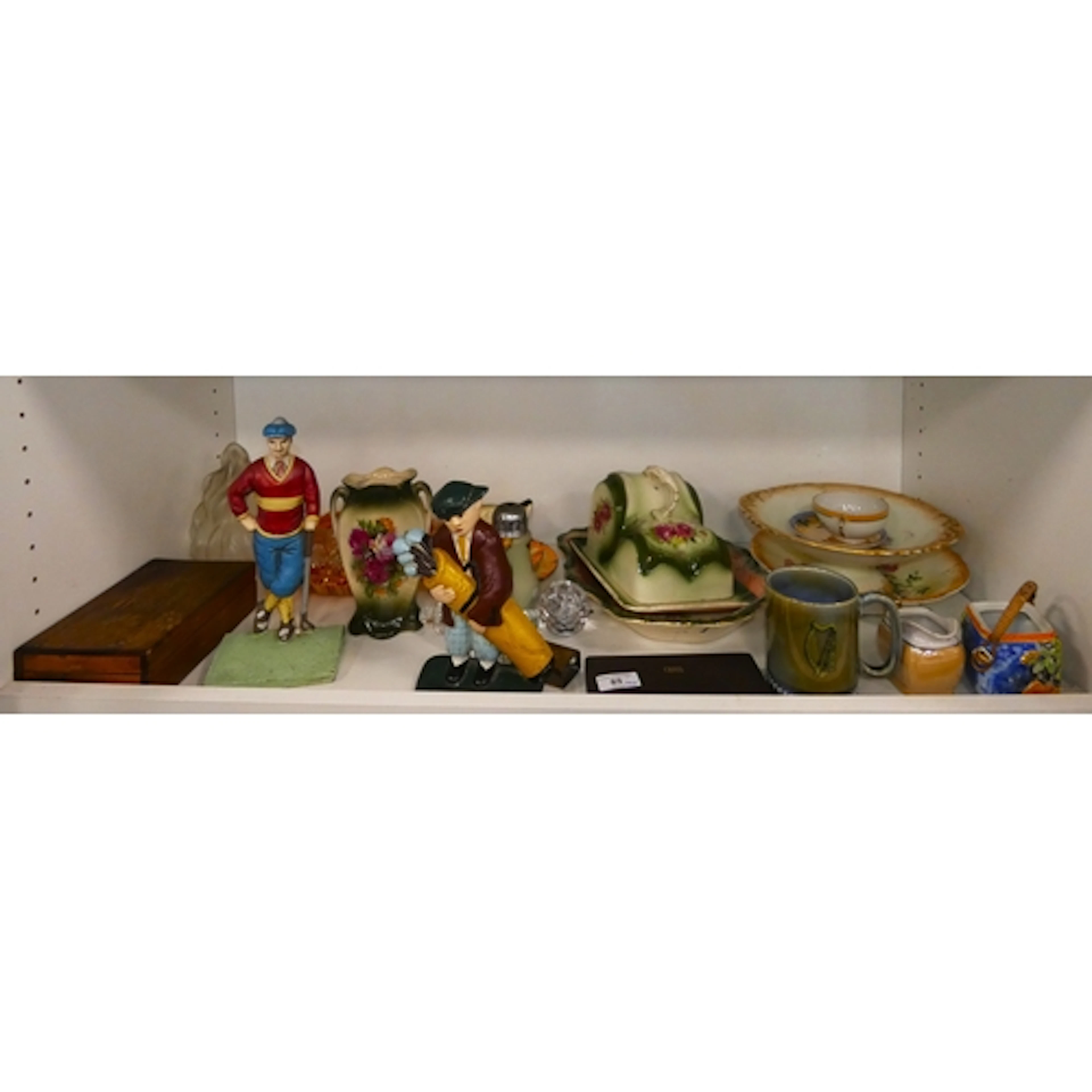 Shelf lot of ceramics to include butter dishes, metal golfin...