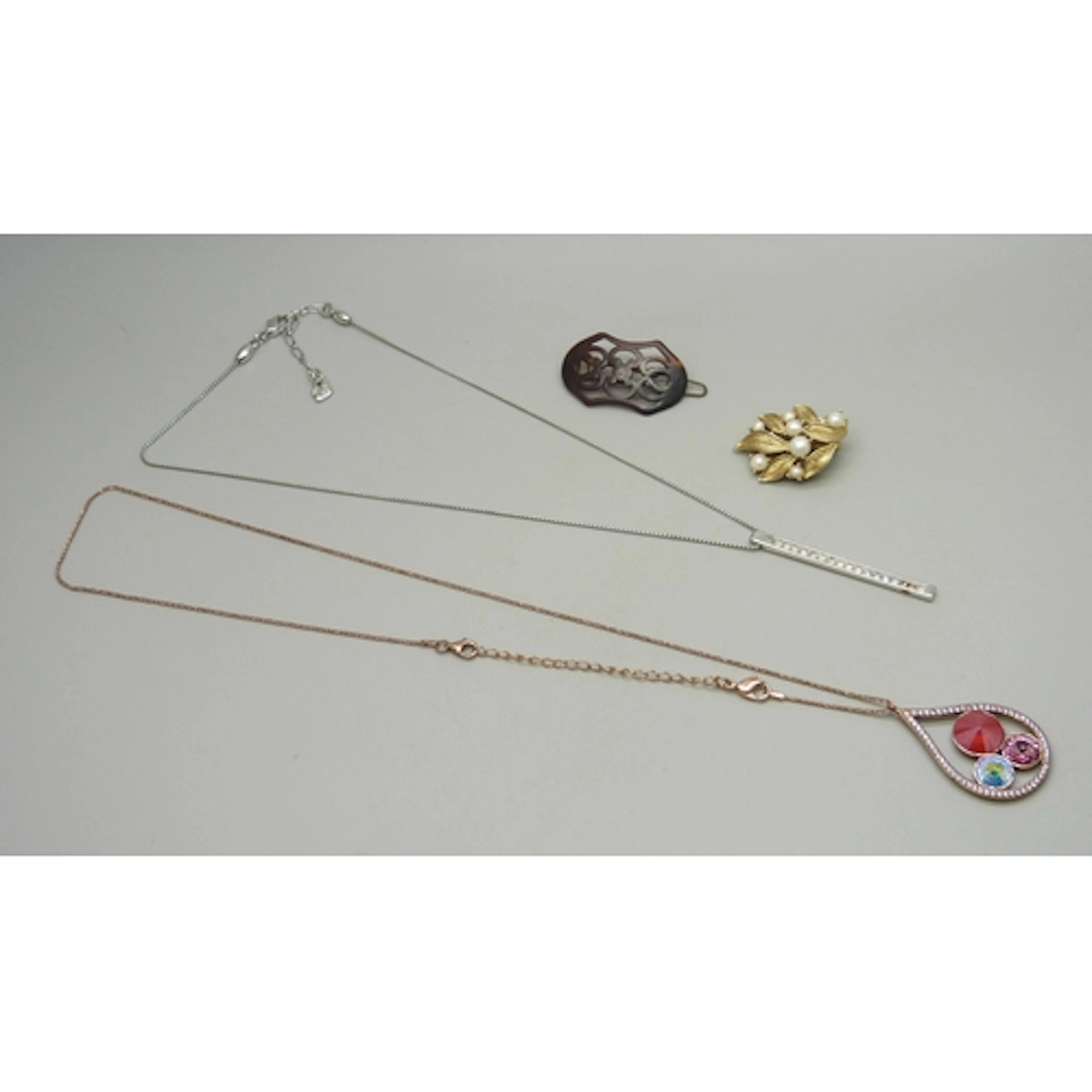 A Swarovski silver tone pendant on chain, a single Trifari e...