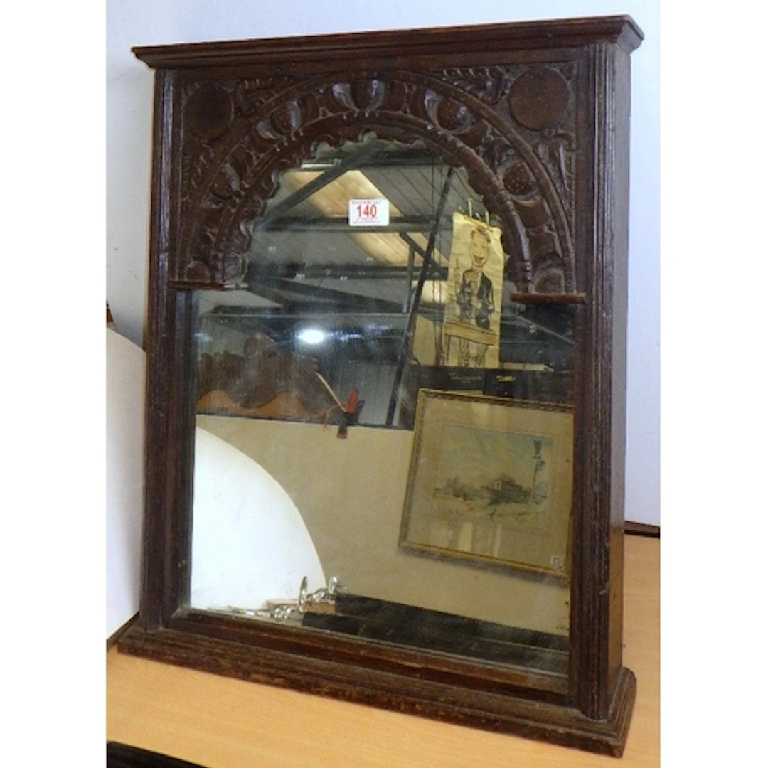 A carved oak table mirror