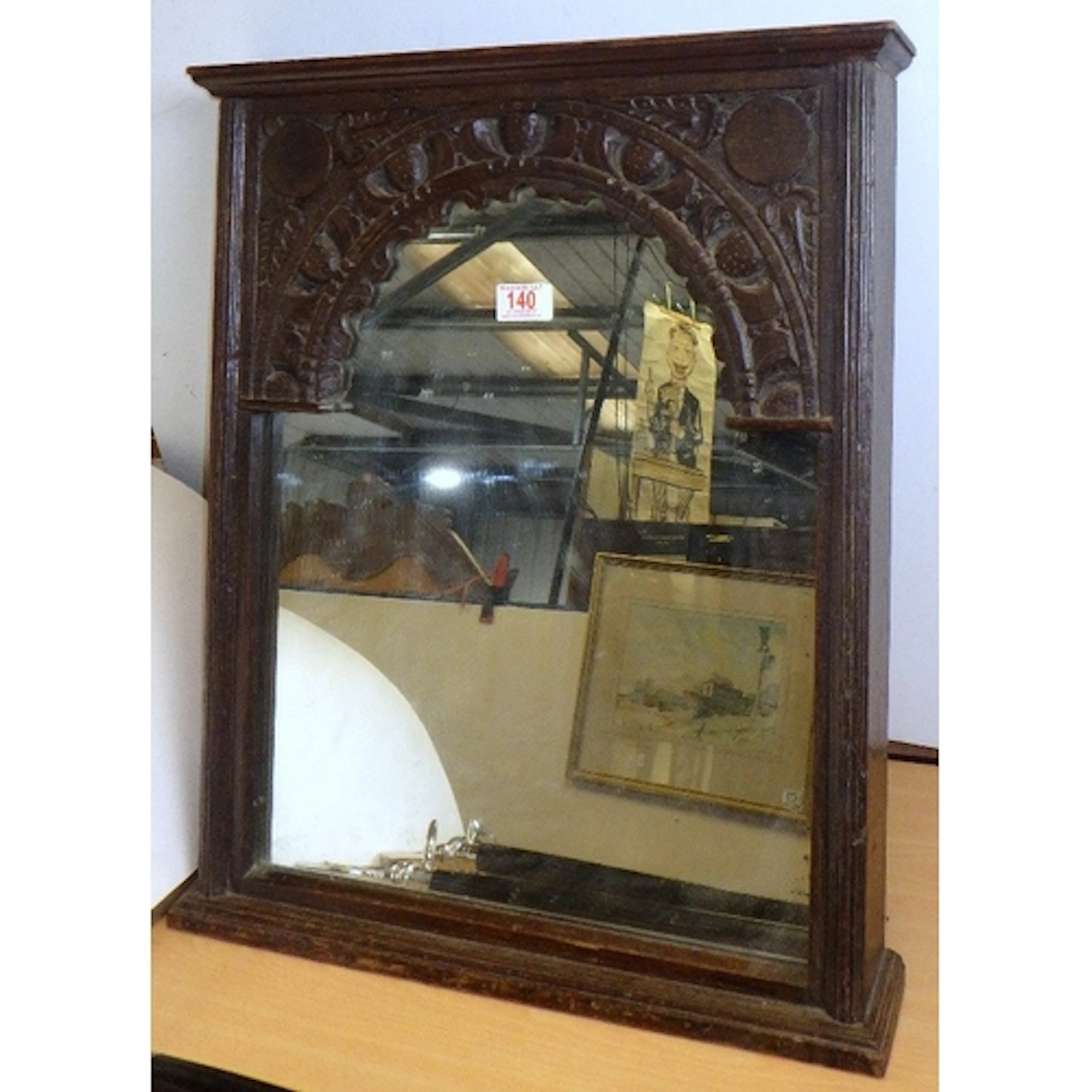 A carved oak table mirror