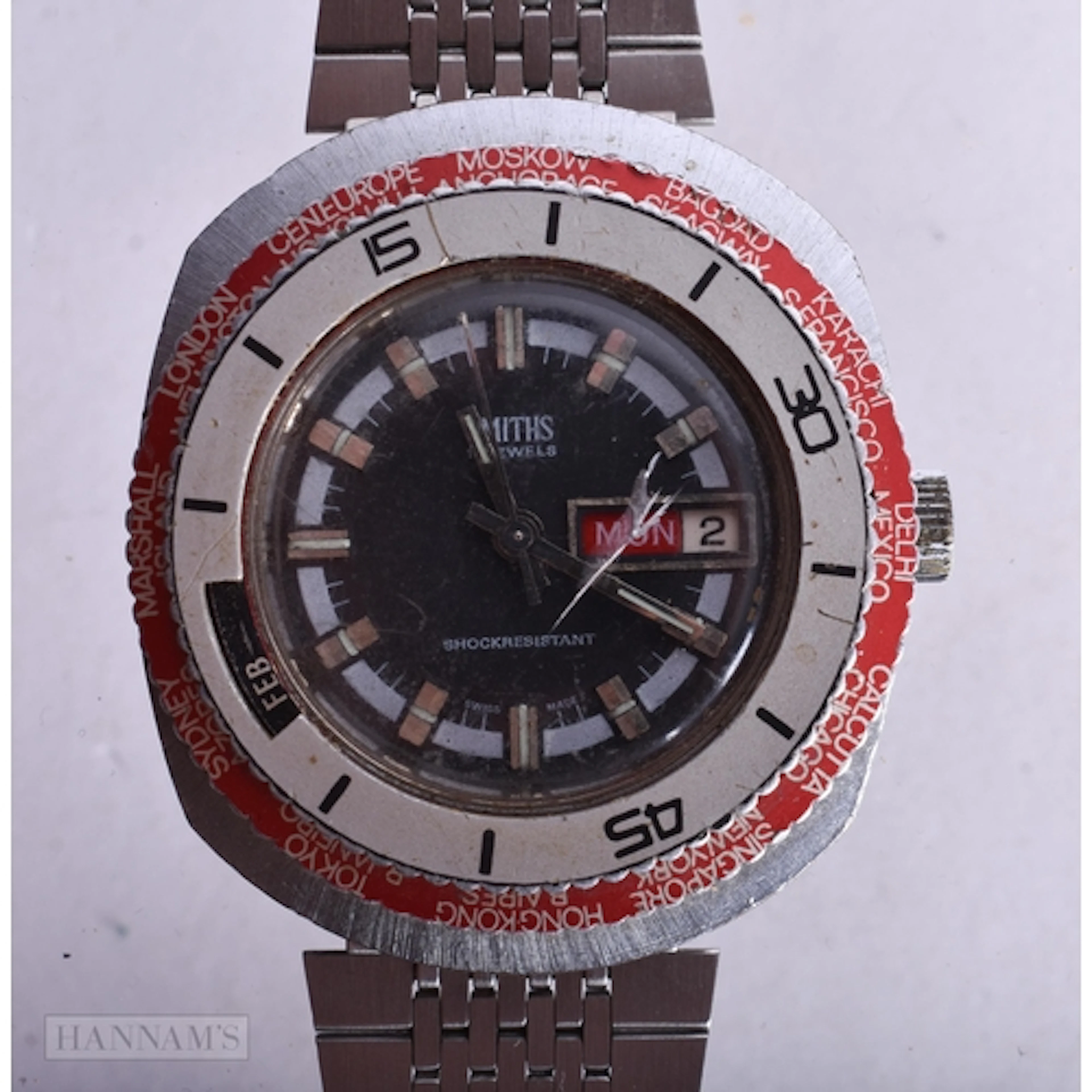AN UNUSUAL SMITHS WORLD TIME TRIPLE CALENDAR WRIST WATCH. No...