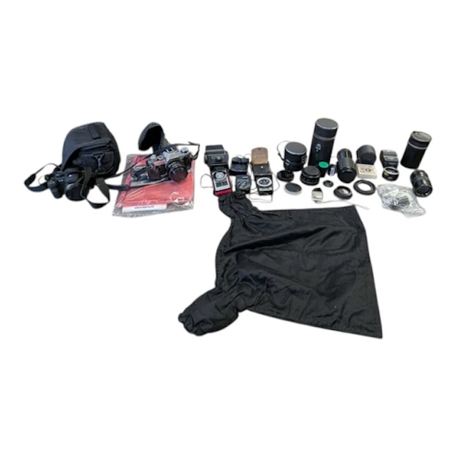 A collection of vintage 20th century camera equipment. The c...