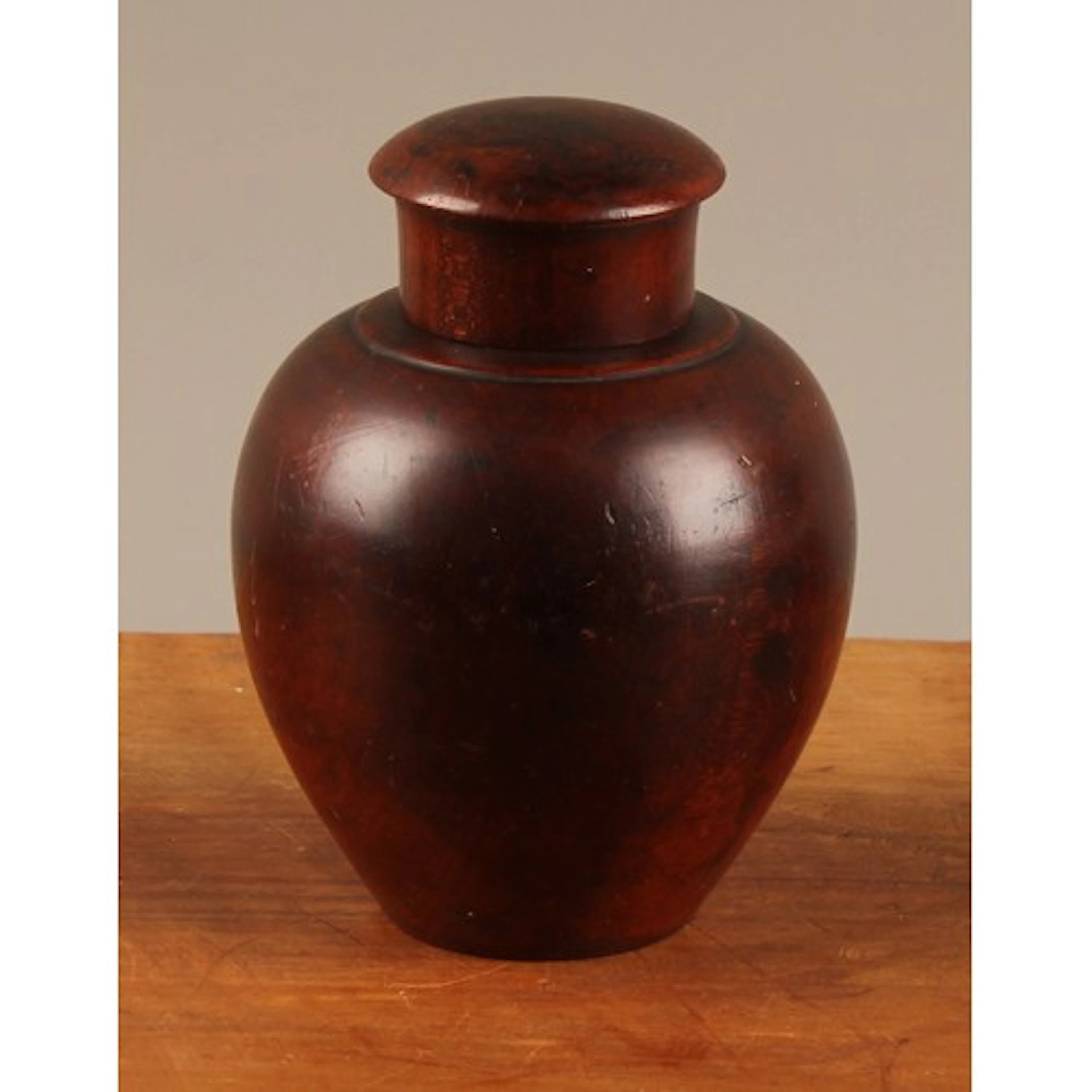 Treen - a George III turned fruitwood ovoid tea caddy, push-...