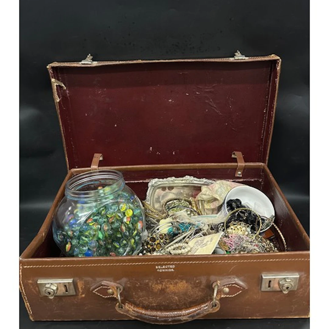 A suitcase containing a collection of costume jewellery and ...