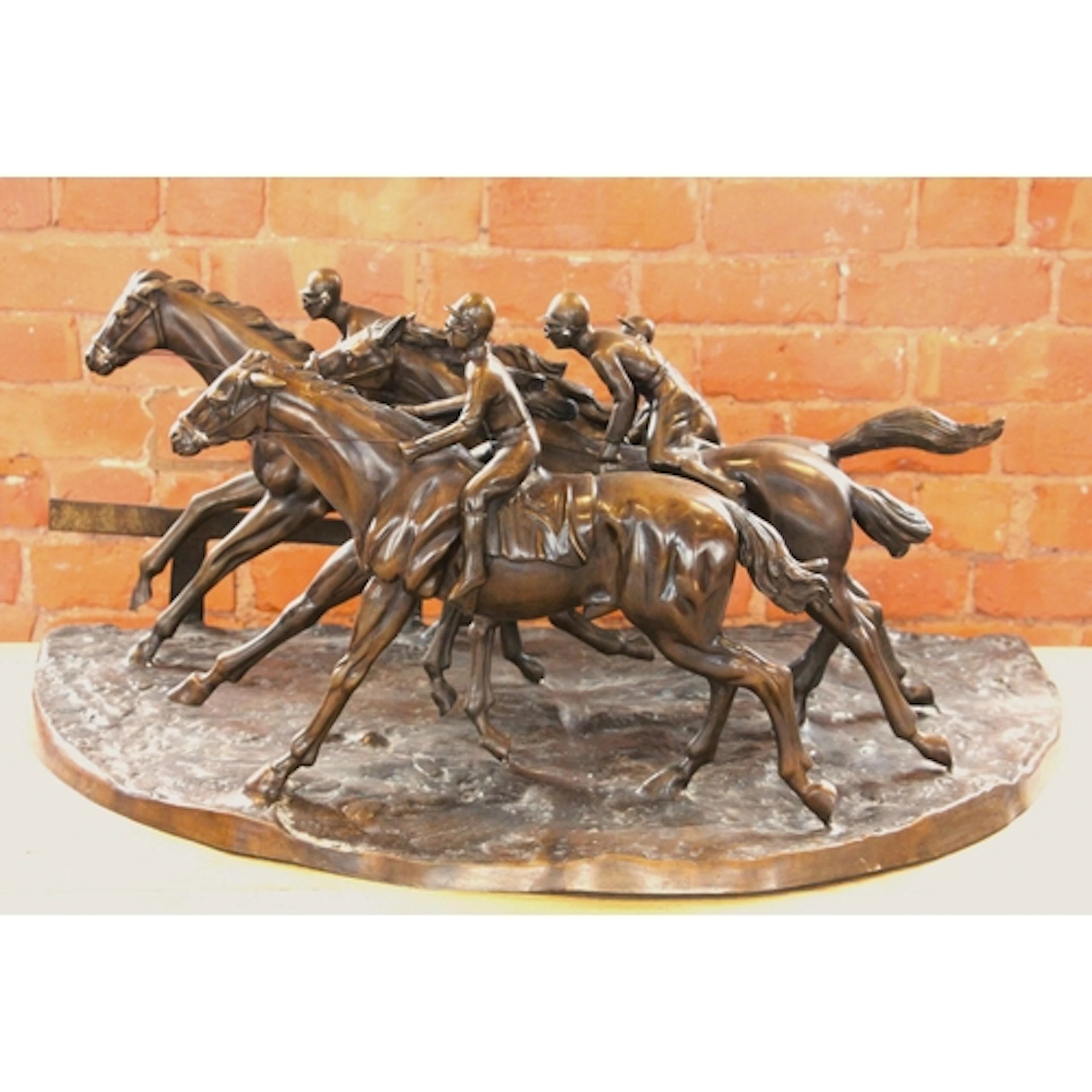 A patinated bronze horseracing group in the manner of John R...