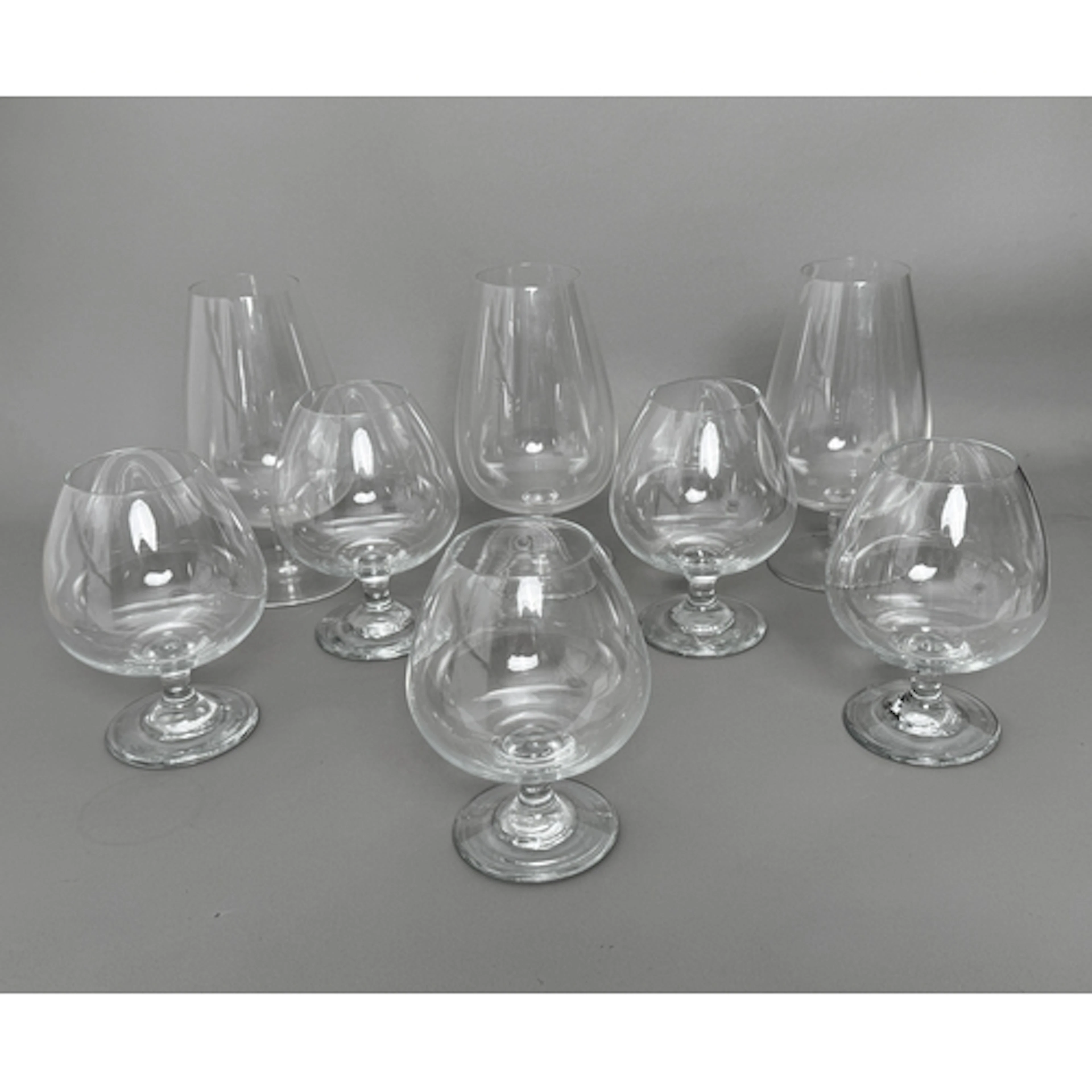 A set of five hand blown, clear glass brandy balloon glasses...