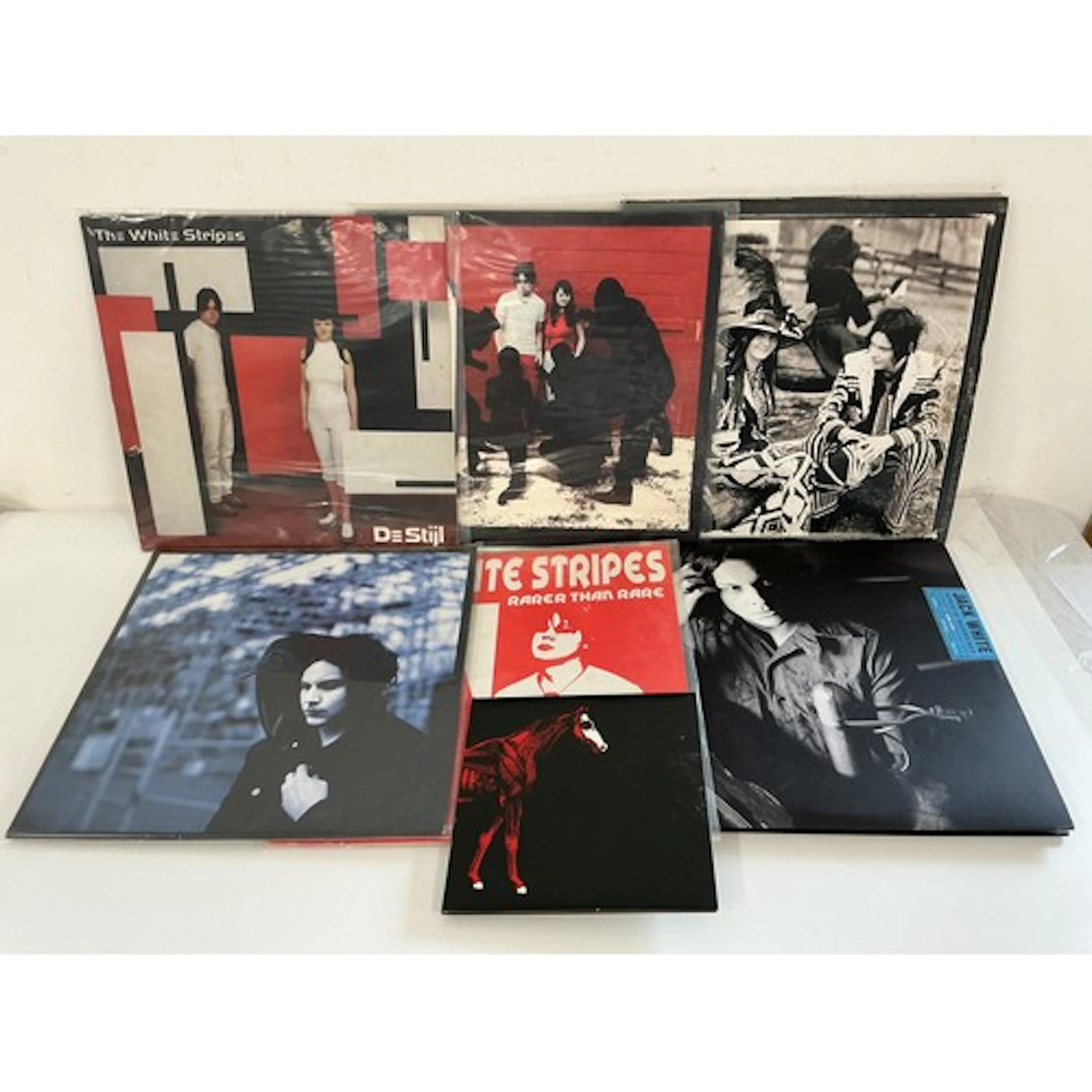 A collection of White Stripes and related LPs and a 7” singl...