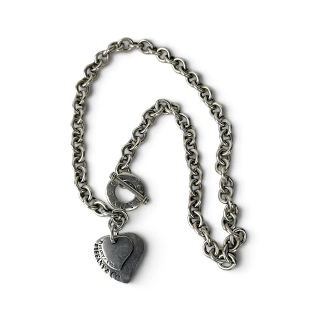 A TIFFANY AND CO SILVER BRACELET With Tiffany and Co charm. ...