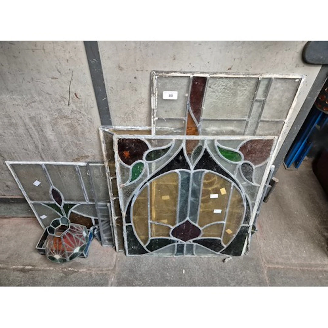 11 stained glass items, mainly window panels.