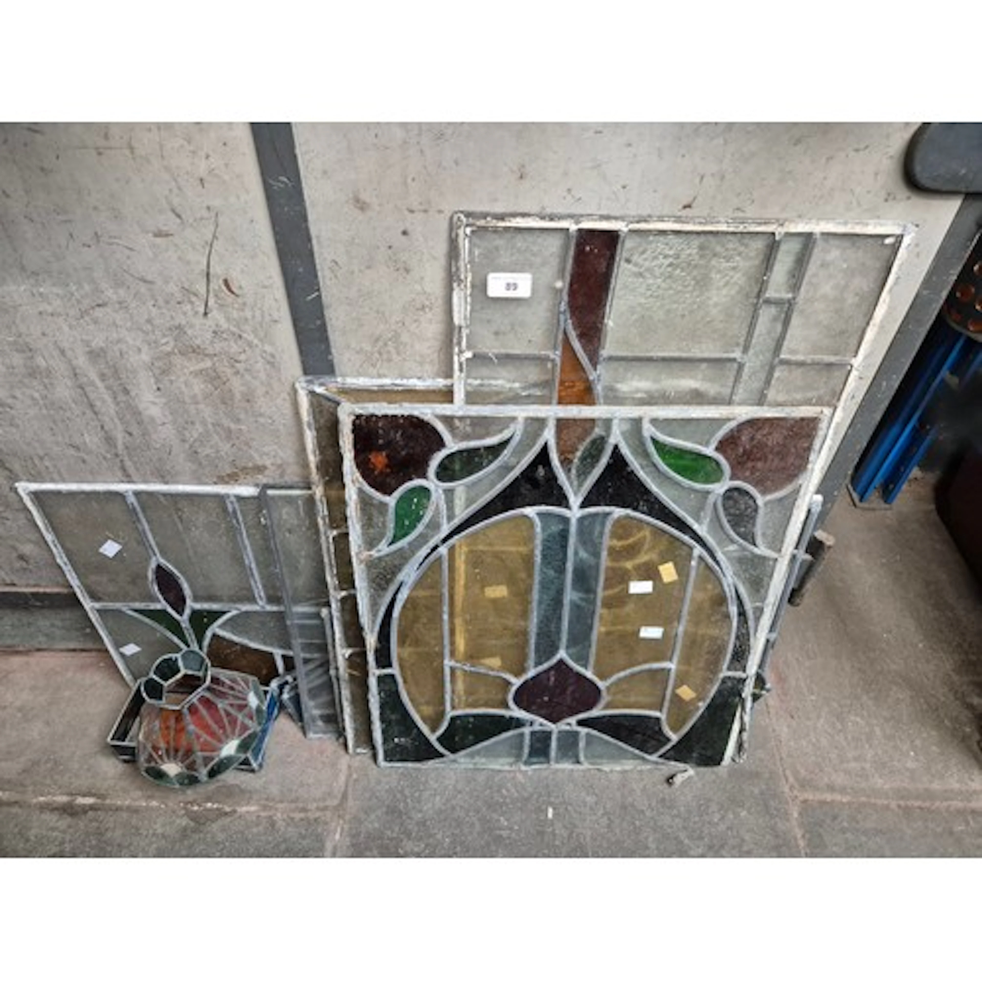 11 stained glass items, mainly window panels.