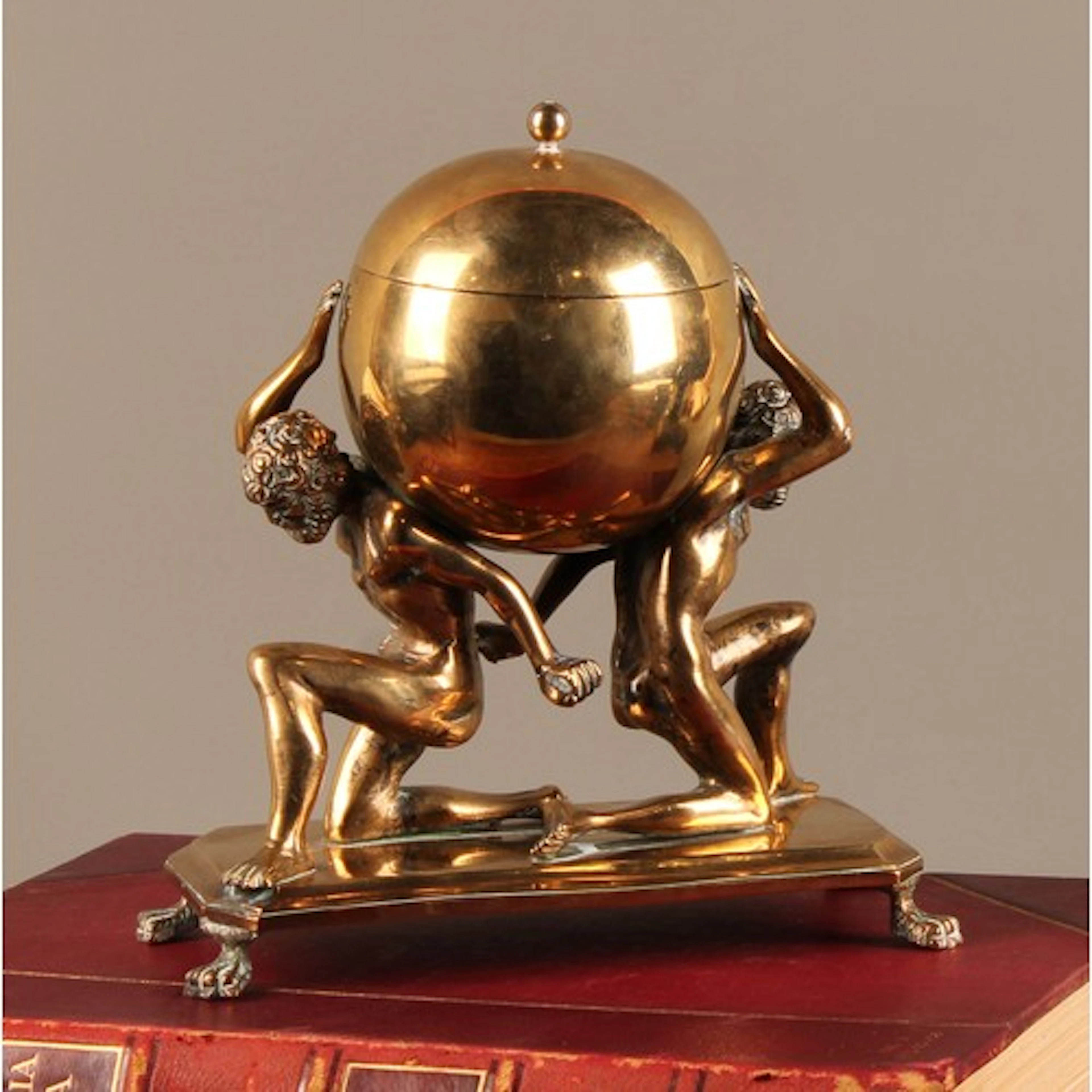 A sculptural 19th century brass inkwell, cast as a pair of A...