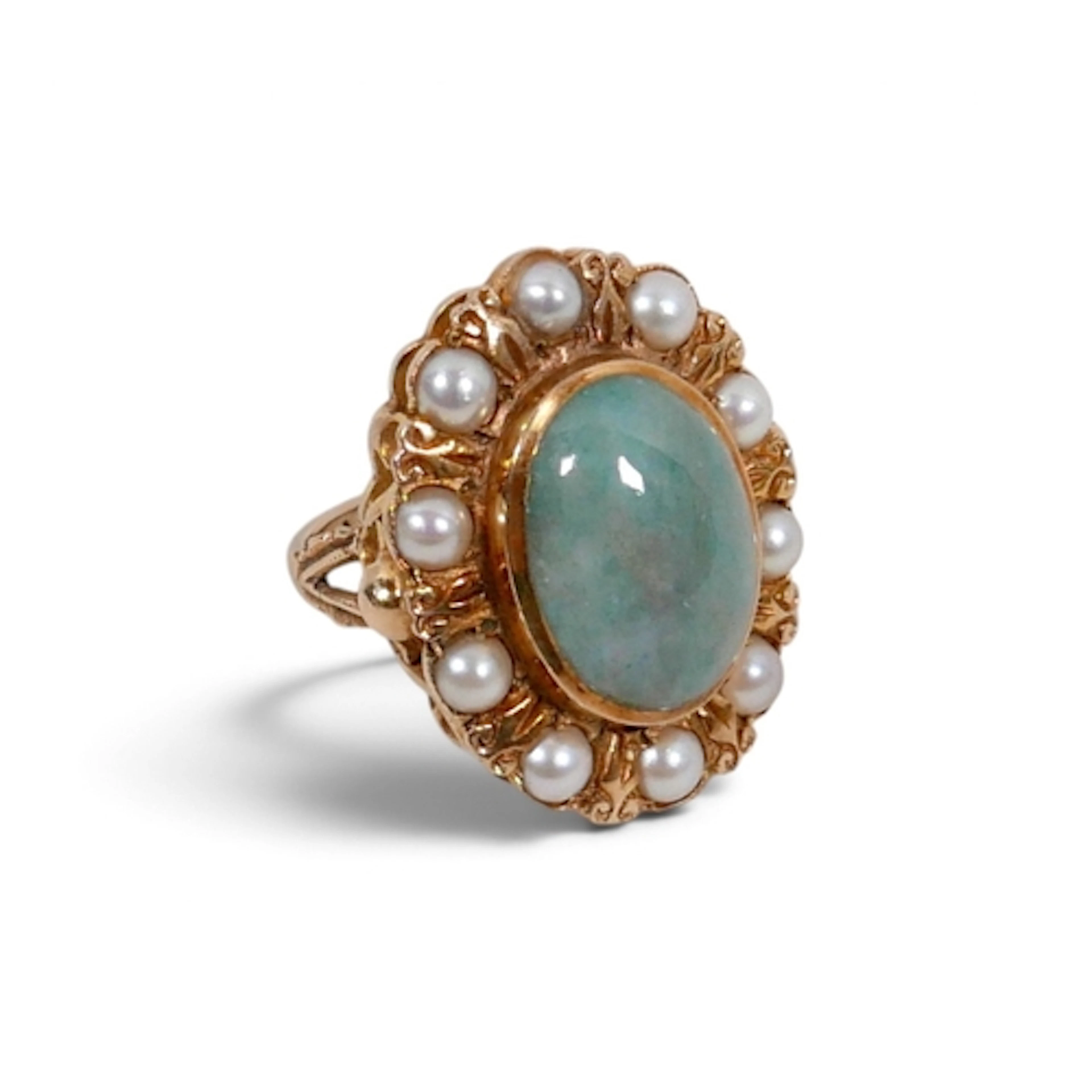 A 9CT GOLD JADE AND PEARL RING. with a jade cabochon surroun...