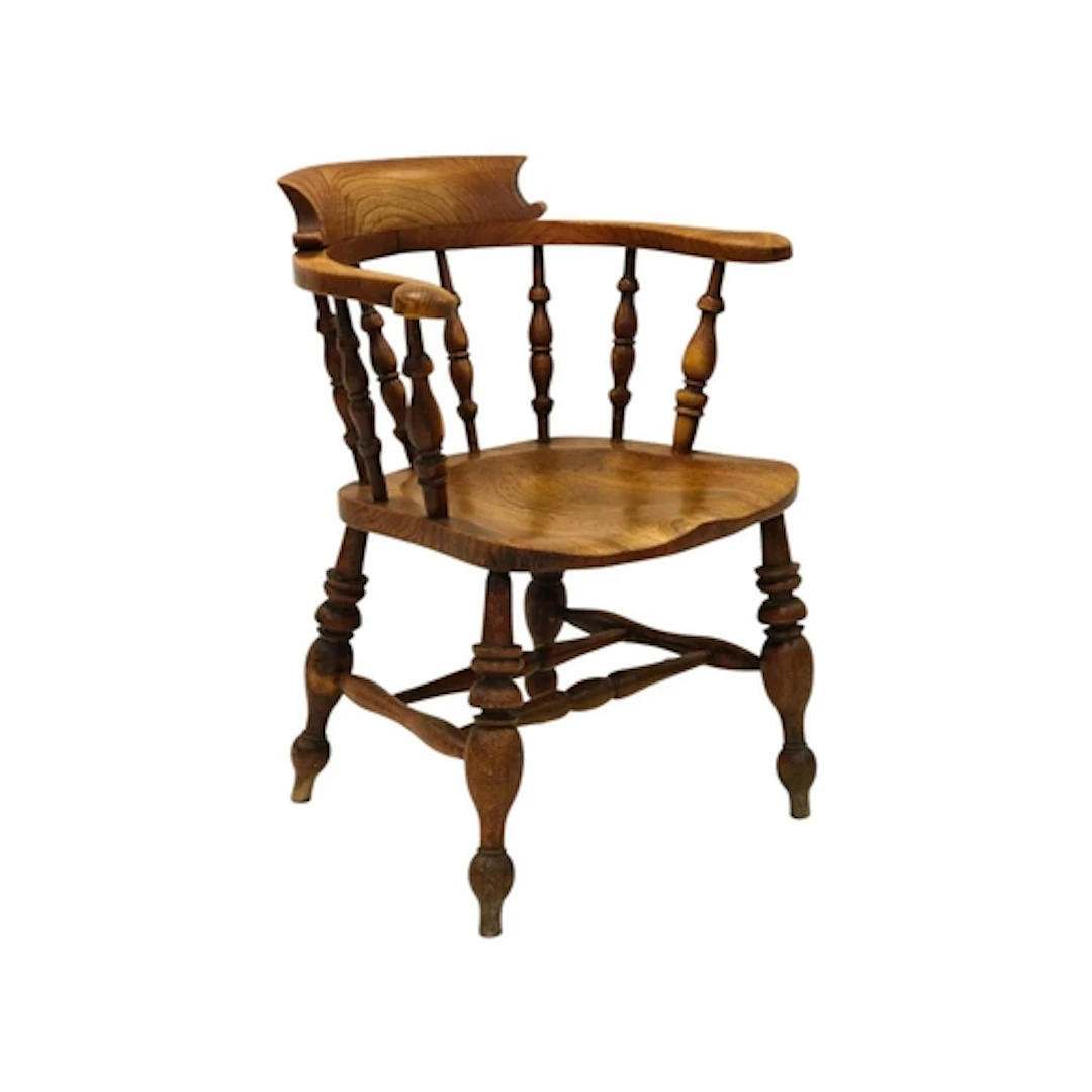 A Victorian ash and elm smoker's bow armchair. With spindle ...