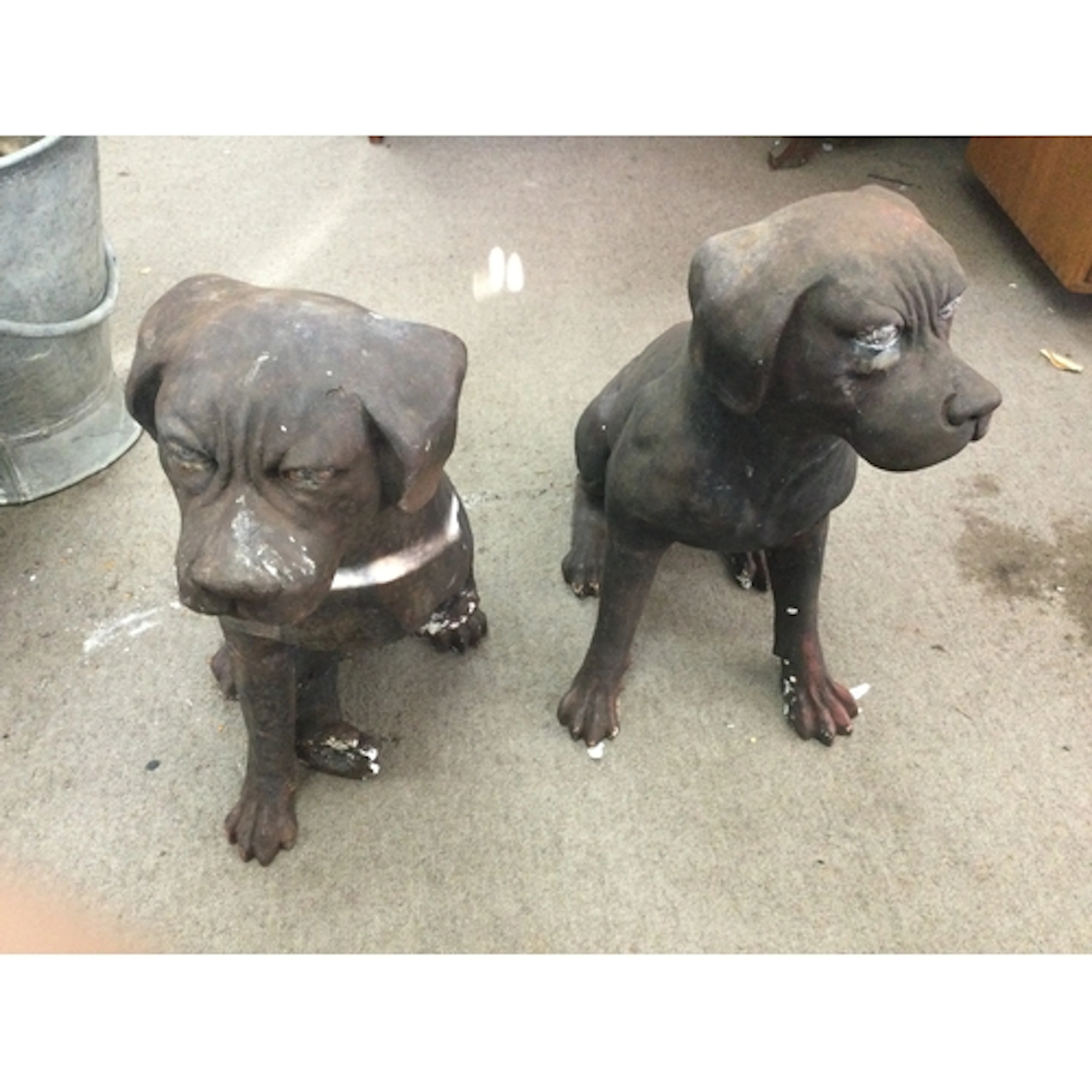 Pair of cast iron dog ornaments, one with a broken leg