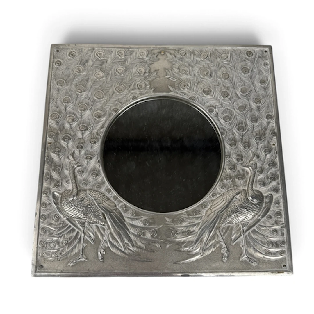 AN INDIAN SILVER PHOTO FRAME DECORATED IN RELIEF WITH A PAIR...