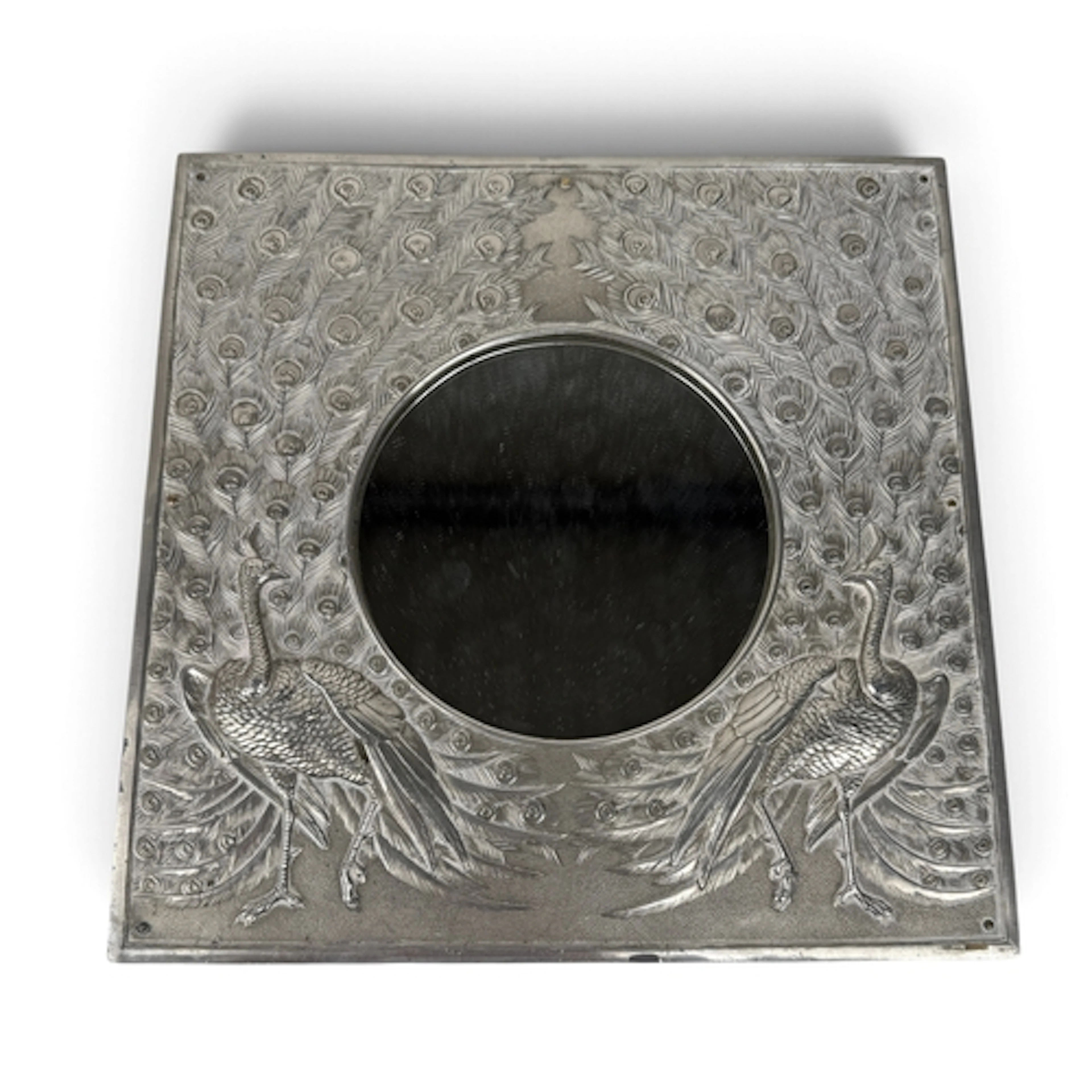 AN INDIAN SILVER PHOTO FRAME DECORATED IN RELIEF WITH A PAIR...