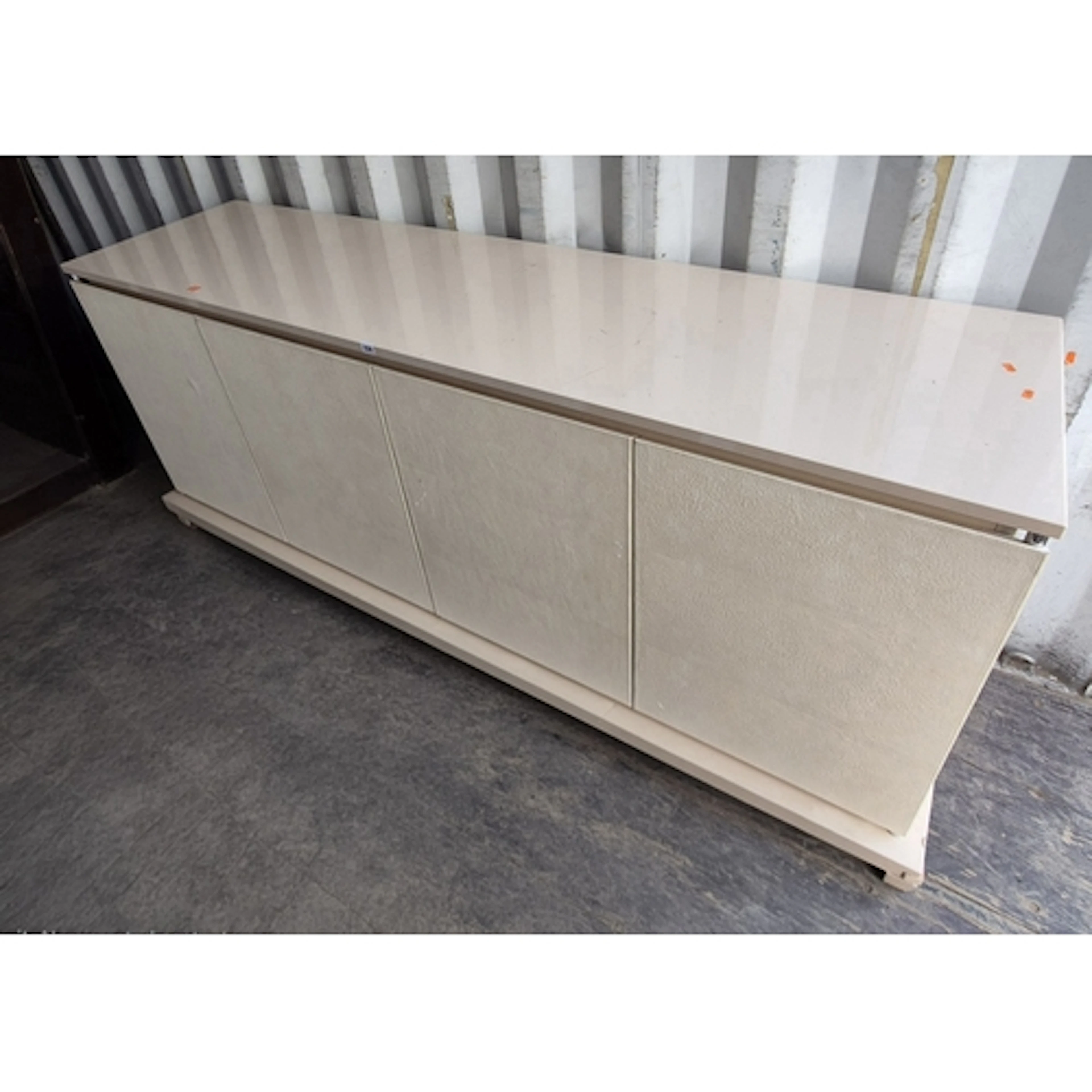 A GLOSSY CREAM FENDI SIDEBOARD, fitted with two cupboard doo...