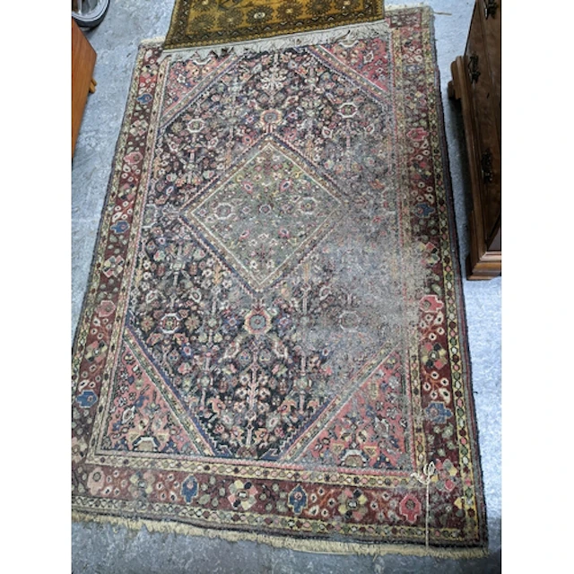 A group of three rugs to include a hand knotted Iranian rug ...
