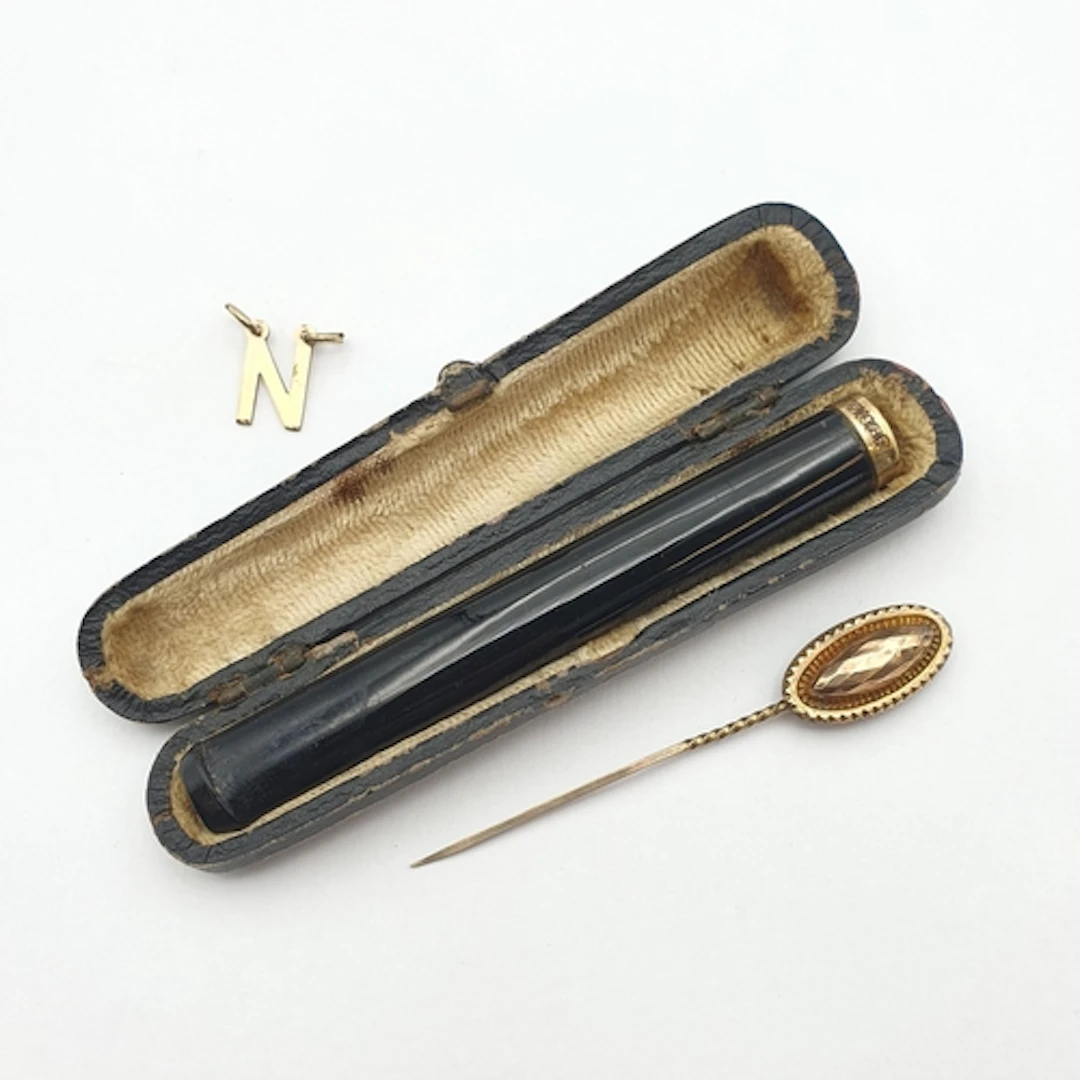 An antique Cheroot Holder in cherry bakelite type material w...