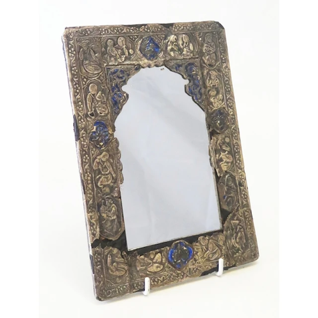 A Persian silver and enamel mirror, the arched mirror plated...