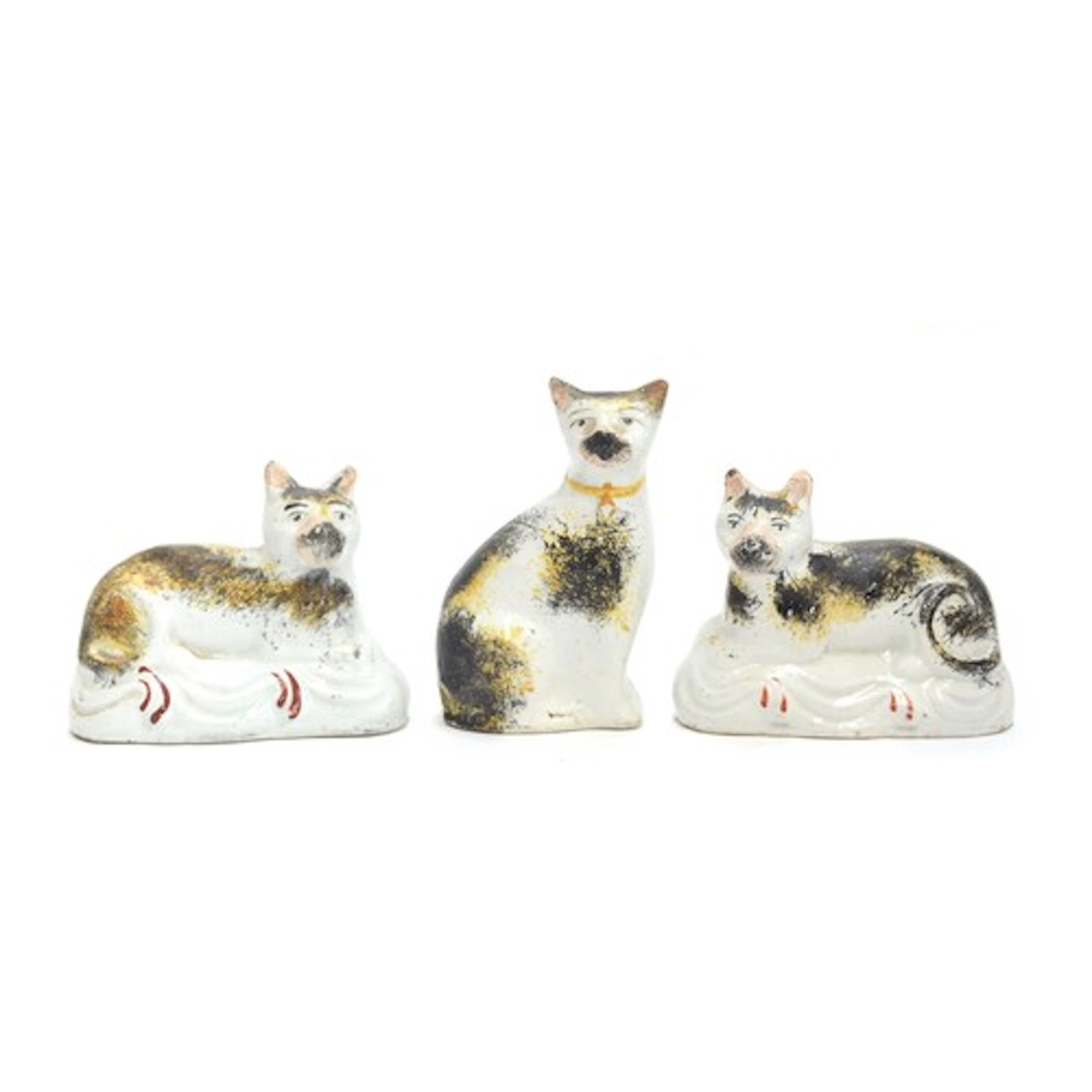 A pair of 19th century Staffordshire recumbent cat figures w...